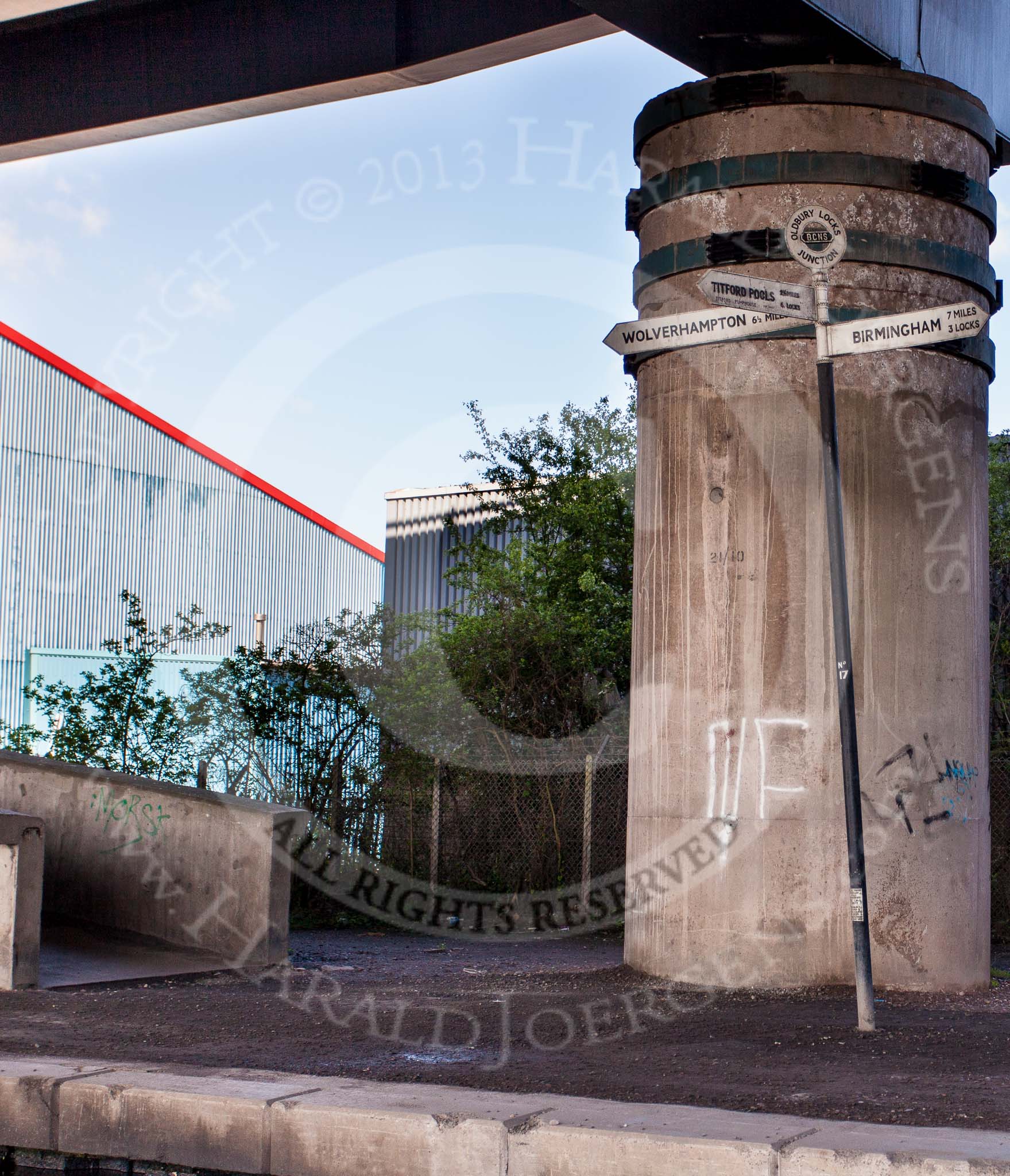 BCN Marathon Challenge 2013: The BCNS signpost at  Oldbury Junction, next to a massive concrete pylon carrying the M5 motorway on the BCN Old Main Line..
Birmingham Canal Navigation,


United Kingdom,
on 25 May 2013 at 10:04, image #137