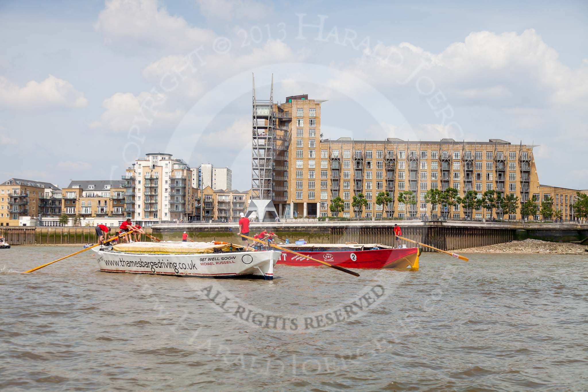 TOW River Thames Barge Driving Race 2013: Barge "Shell Bay" by South Dock Marina, followed by barge "Jane", by the RMT Union, near Canary Wharf Pier..
River Thames between Greenwich and Westminster,
London,

United Kingdom,
on 13 July 2013 at 13:15, image #299