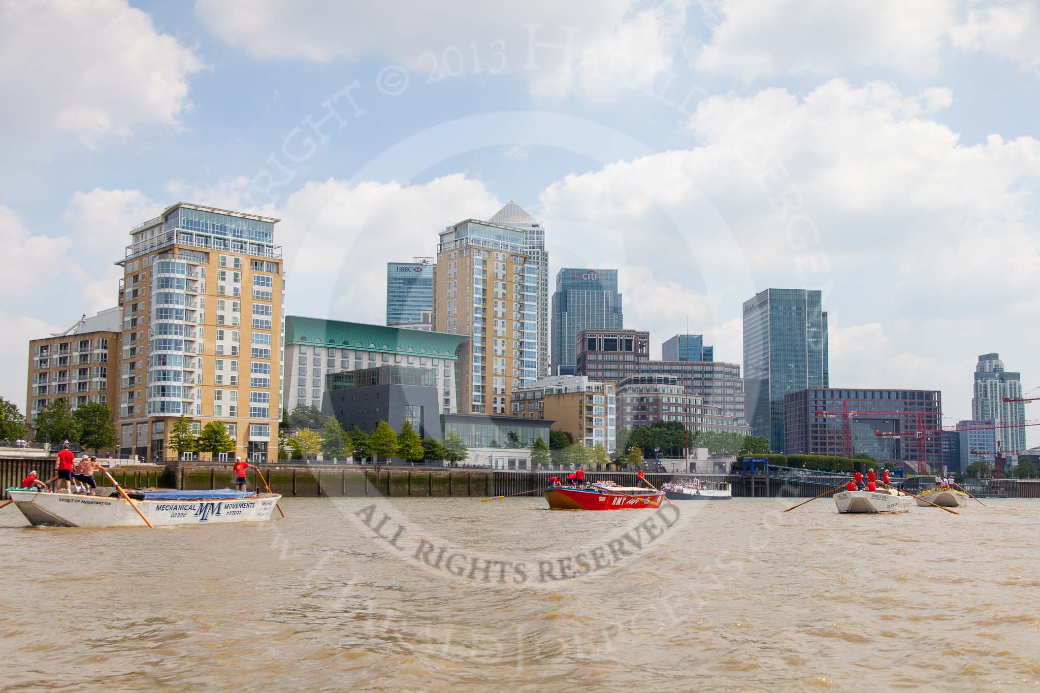 TOW River Thames Barge Driving Race 2013: Barge "Spirit of Mountabatten", by Mechanical Movements and Enabling Services Ltd, followed by "Jane", by the RMT Union, barge"Shell Bay" by South Dock Marina, and barge "Hoppy", by GPS Fabrication, in front of the skyscrapers at Canary Wharf..
River Thames between Greenwich and Westminster,
London,

United Kingdom,
on 13 July 2013 at 13:17, image #306