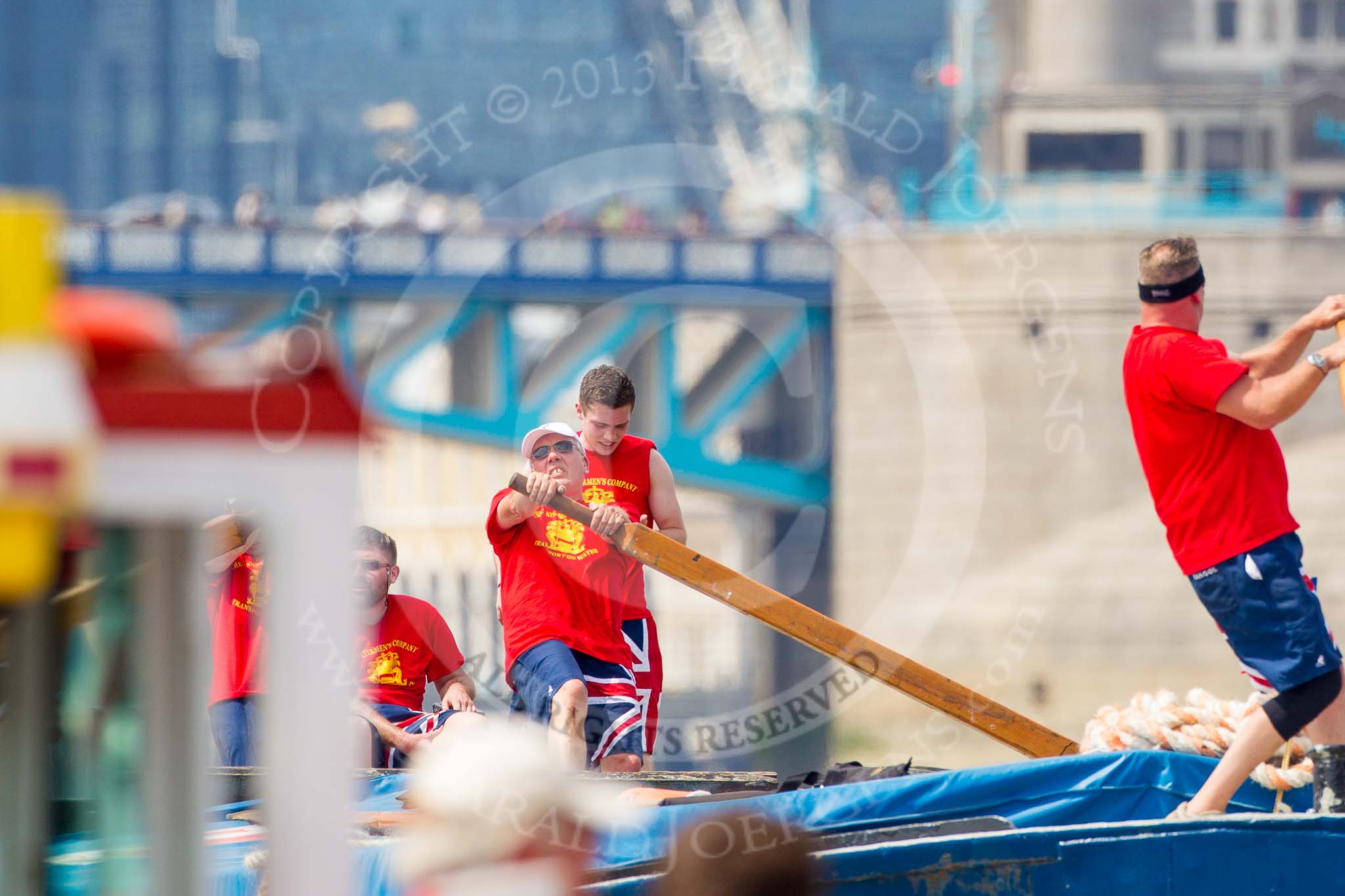 TOW River Thames Barge Driving Race 2013: Rowers on deck of barge "Diana", by Trinity Buoy Wharf, as the barge approaches Tower Bridge..
River Thames between Greenwich and Westminster,
London,

United Kingdom,
on 13 July 2013 at 13:34, image #362