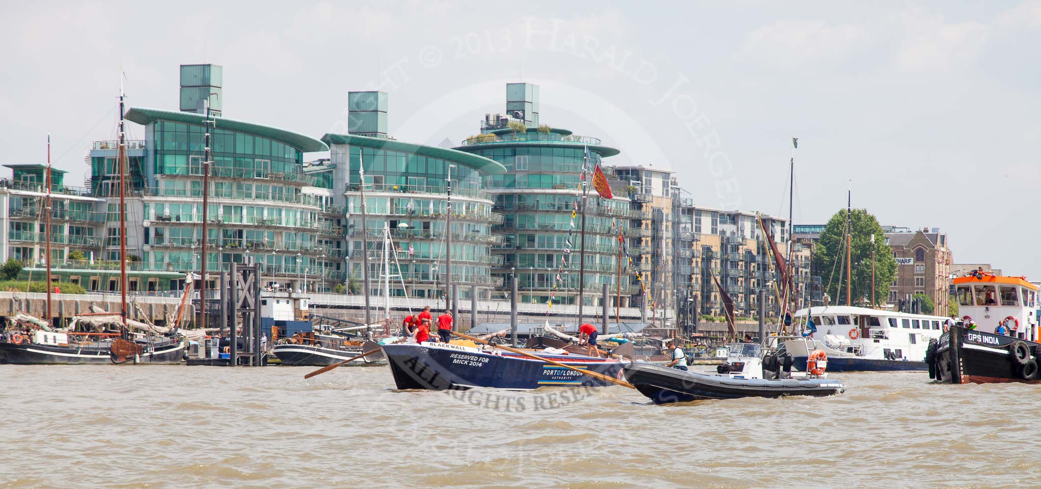 TOW River Thames Barge Driving Race 2013: Barge  "Blackwall", by the Port of London Authority, passing modern buildings at Wapping Hight Street..
River Thames between Greenwich and Westminster,
London,

United Kingdom,
on 13 July 2013 at 13:40, image #375