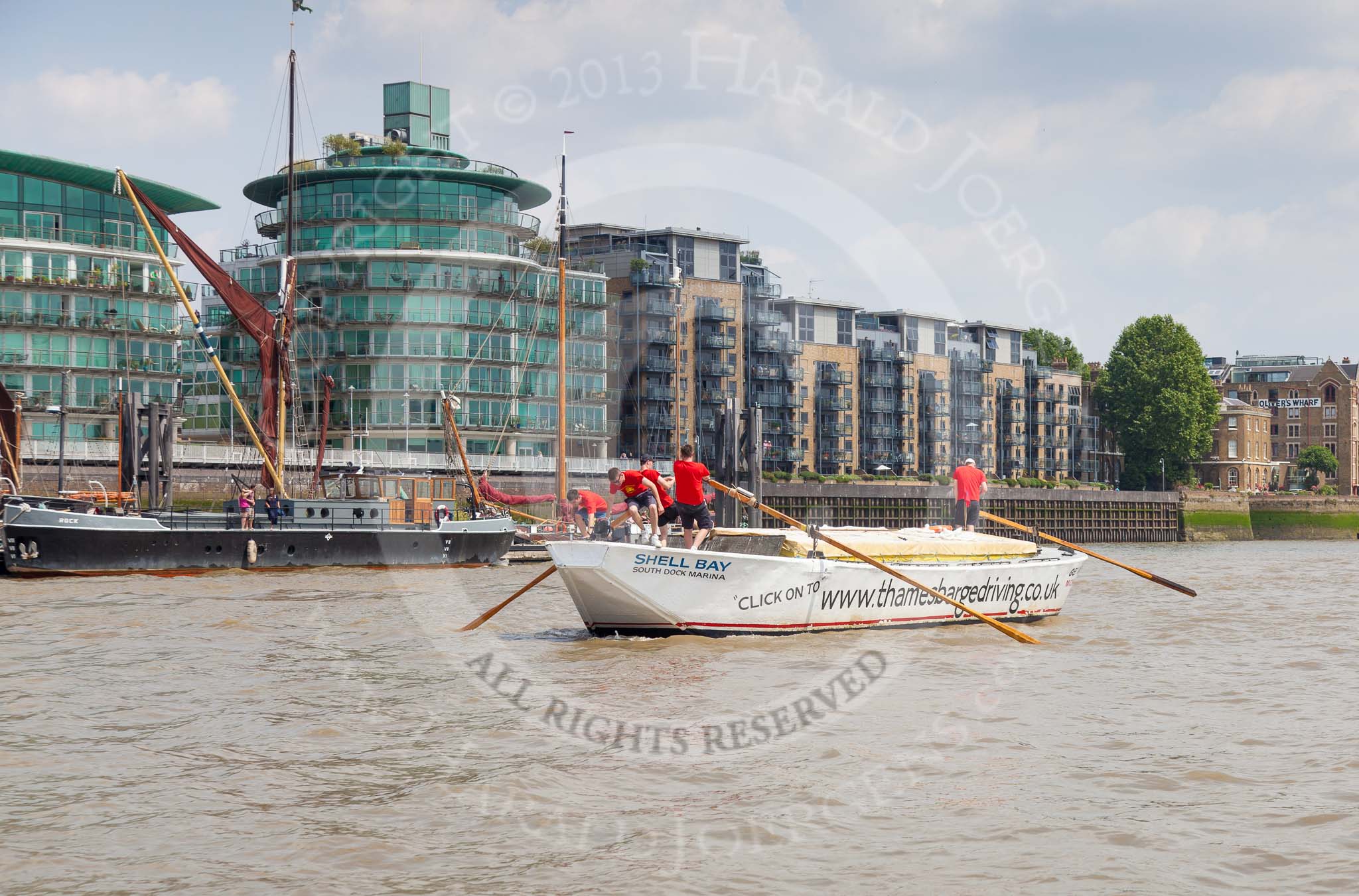 TOW River Thames Barge Driving Race 2013: Barge "Shell Bay" by South Dock Marina, passing modern buildings at Wapping Hight Street..
River Thames between Greenwich and Westminster,
London,

United Kingdom,
on 13 July 2013 at 13:43, image #379