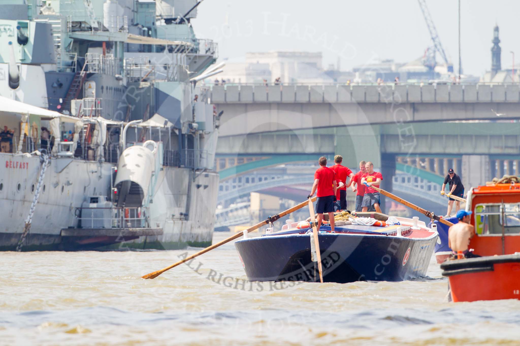 TOW River Thames Barge Driving Race 2013: Barge "Blackwall", by the Port of London Authority, passing HMS Belfast. In front, on the right, barge "Steve Faldo" by Capital Pleasure Boats..
River Thames between Greenwich and Westminster,
London,

United Kingdom,
on 13 July 2013 at 13:45, image #387