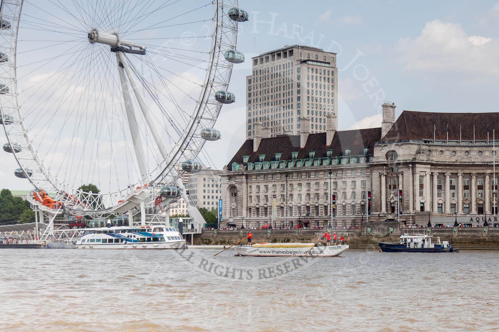 TOW River Thames Barge Driving Race 2013: Barge ""Shell Bay" by South Dock Marina, with the London Eye and London Aquarium behind, close to the finish of the race at Westminster Bridge..
River Thames between Greenwich and Westminster,
London,

United Kingdom,
on 13 July 2013 at 14:23, image #445