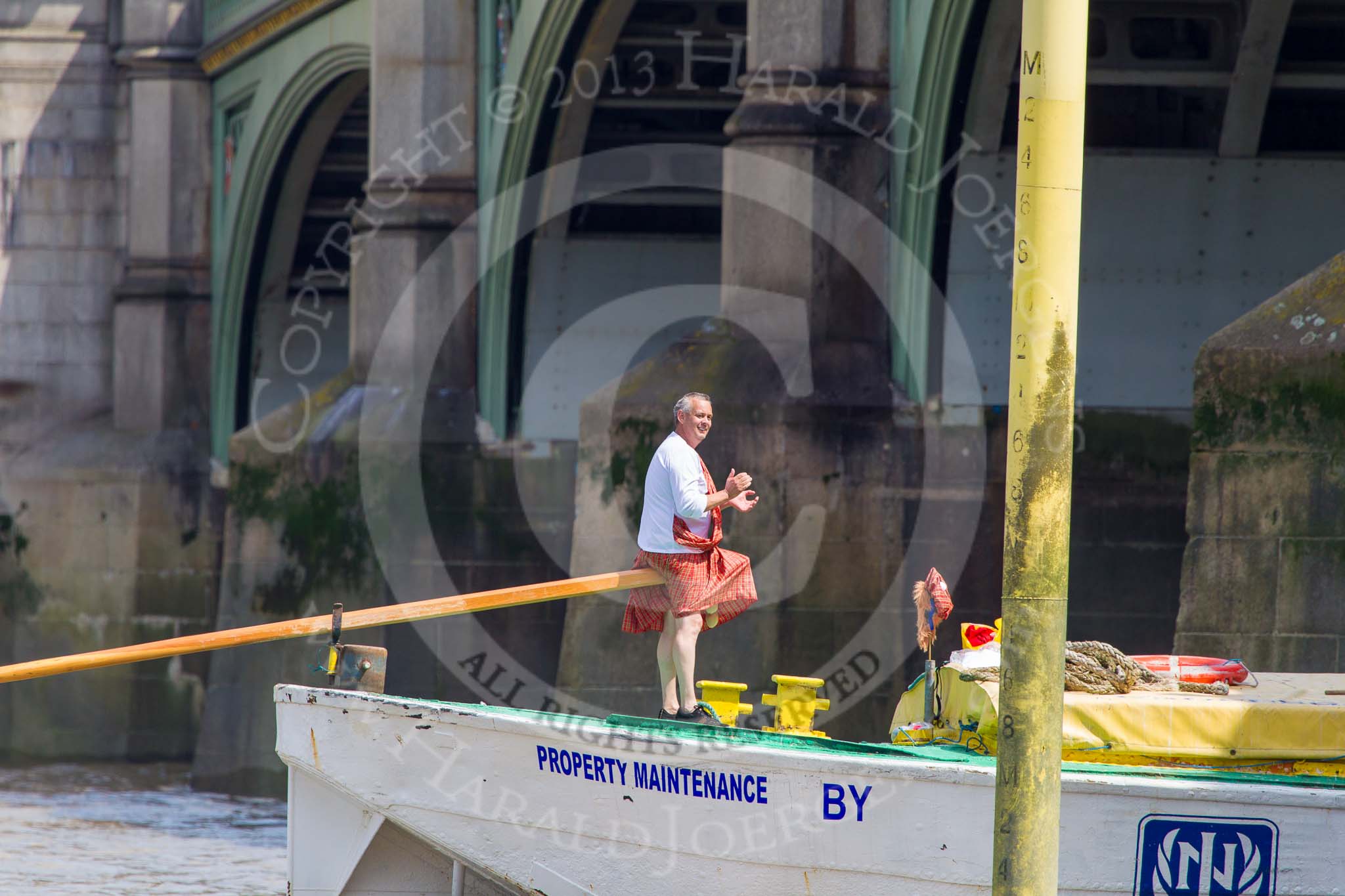 TOW River Thames Barge Driving Race 2013: The steerer, applauding, as barge "Hoppy", by GPS Fabrication, crosses the finish line of the race at Westminster Bridge..
River Thames between Greenwich and Westminster,
London,

United Kingdom,
on 13 July 2013 at 14:27, image #466