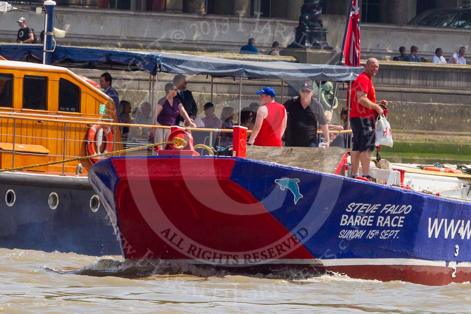 TOW River Thames Barge Driving Race 2013: Barge "Steve Faldo" by Capital Pleasure Boats, behind the finish line at Westminster Bridge, ready to be towed back to Greenwich by tug "Bulldog". Behind them is MV Havengore, hosting VIP guests..
River Thames between Greenwich and Westminster,
London,

United Kingdom,
on 13 July 2013 at 14:33, image #485