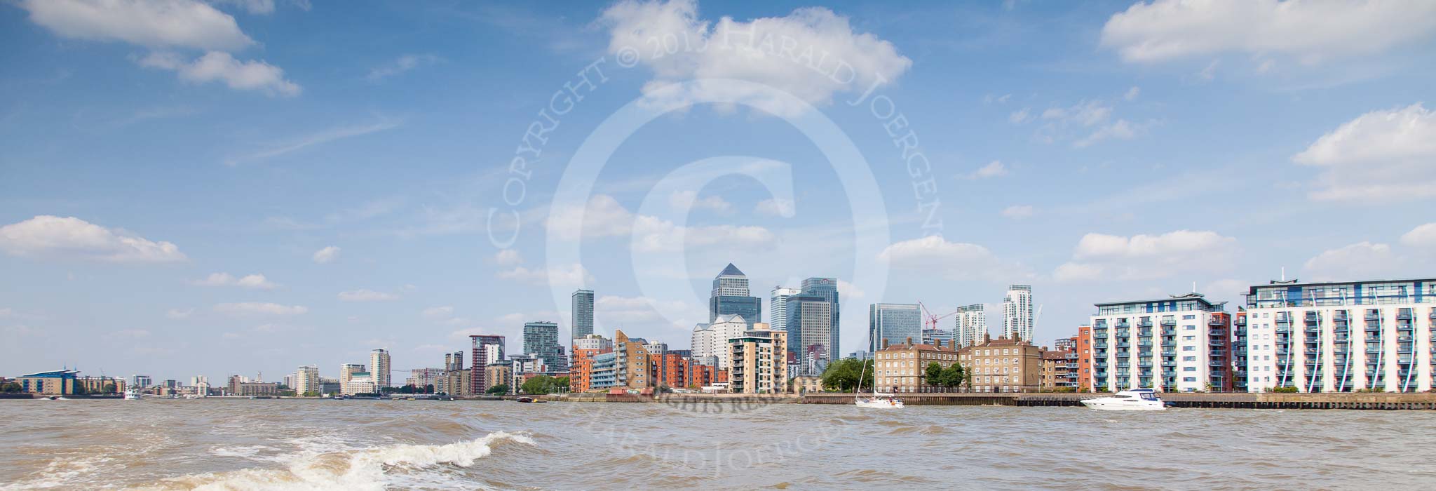 TOW River Thames Barge Driving Race 2013: Wide angle view of the east of London from the river, with the ckyscapers of Canary Wharf on the right..
River Thames between Greenwich and Westminster,
London,

United Kingdom,
on 13 July 2013 at 15:18, image #553