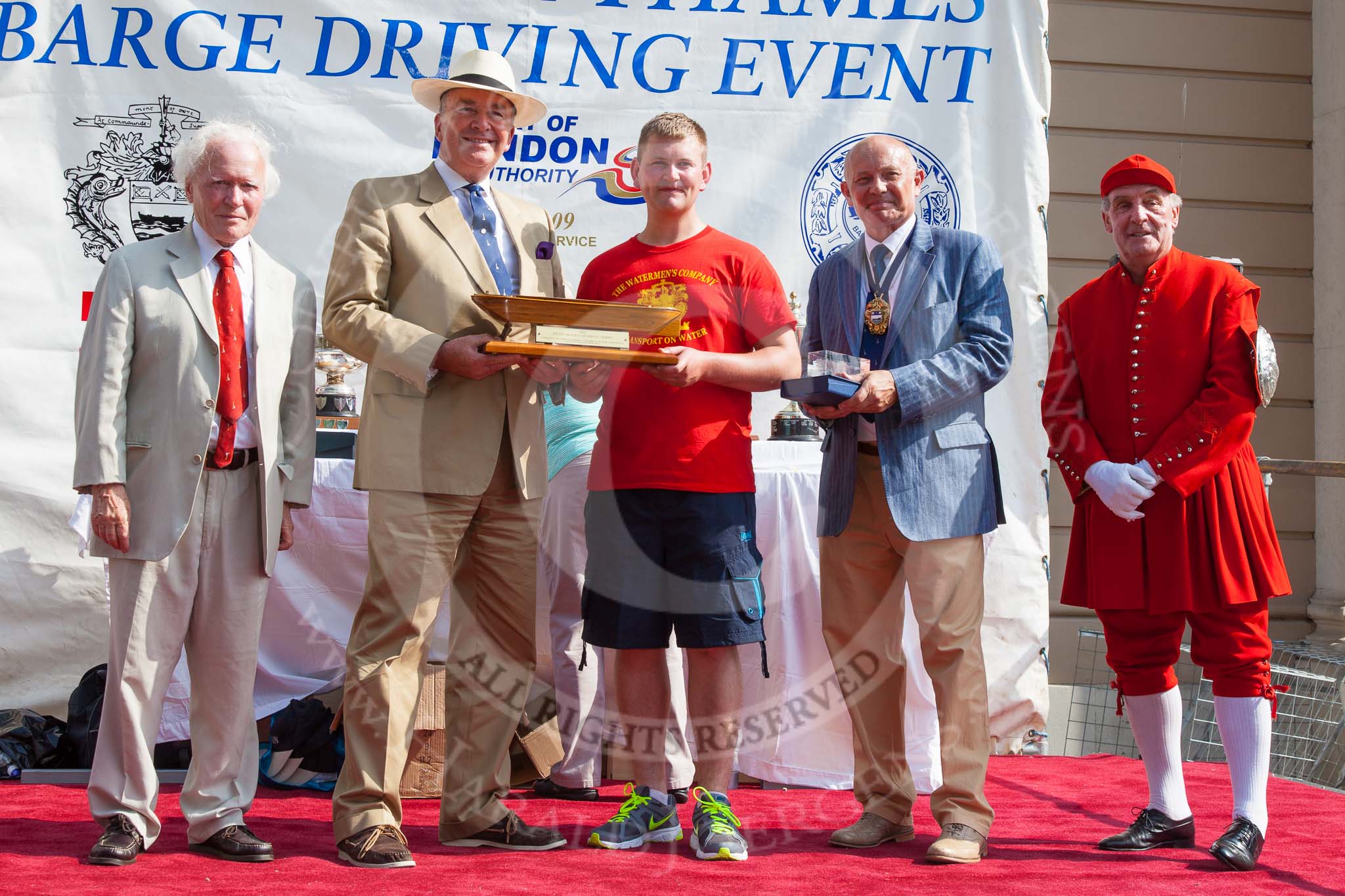 TOW River Thames Barge Driving Race 2013: The "Steven Bennet Memorial Trophy", presented to the apprentice on the winning barge, goes to M. O'Doherty of barge  "Blackwall", by the Port of London Authority..
River Thames between Greenwich and Westminster,
London,

United Kingdom,
on 13 July 2013 at 16:28, image #578