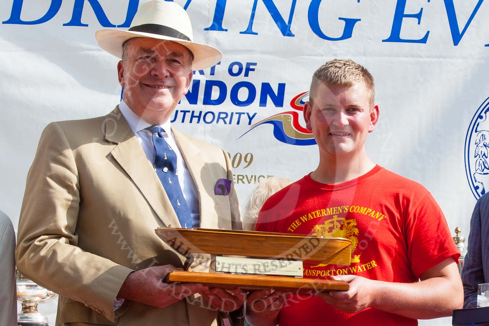 TOW River Thames Barge Driving Race 2013: The "Steven Bennet Memorial Trophy", presented to the apprentice on the winning barge, goes to M. O'Doherty of barge  "Blackwall", by the Port of London Authority. Here Admiral Alan West with M. O'Doherty and the trophy..
River Thames between Greenwich and Westminster,
London,

United Kingdom,
on 13 July 2013 at 16:28, image #579