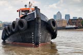 TOW River Thames Barge Driving Race 2013: The bow of GPS Marine tug "GPS Vincia" at close distance. In the background the skyscrapers of Canary Wharf..
River Thames between Greenwich and Westminster,
London,

United Kingdom,
on 13 July 2013 at 13:30, image #351