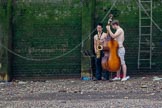 TOW River Thames Barge Driving Race 2013: Two young male musicians playing their instruments by the river..
River Thames between Greenwich and Westminster,
London,

United Kingdom,
on 13 July 2013 at 13:32, image #353