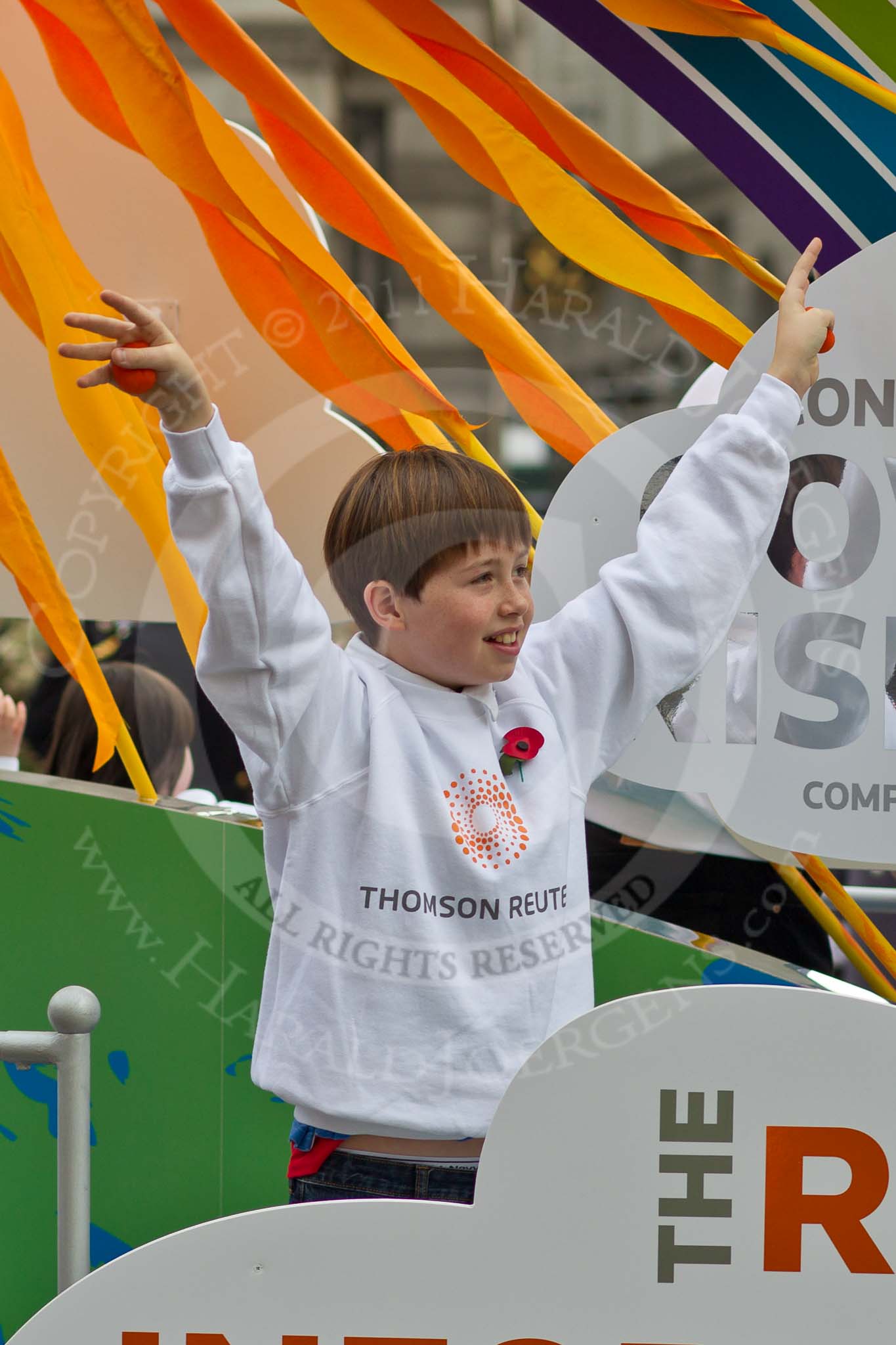 The Lord Mayor's Show 2011: Thomson Reuters (http://www.thomsonreuters.com/), delivering critical information to the financial, legal, tax and accounting, science and media markets. Close-up of a young boy..
Opposite Mansion House, City of London,
London,
-,
United Kingdom,
on 12 November 2011 at 11:16, image #195