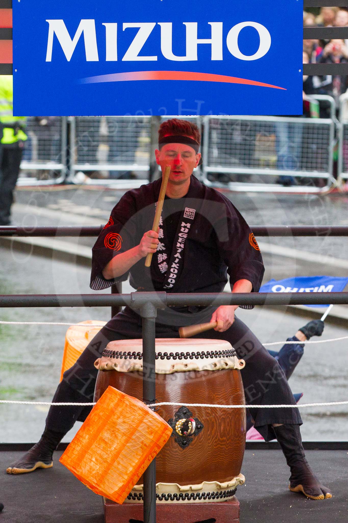 Lord Mayor's Show 2012: Entry 6, Mizuho Corporate Bank, with the drum group Mugenkyo Taiko..
Press stand opposite Mansion House, City of London,
London,
Greater London,
United Kingdom,
on 10 November 2012 at 11:01, image #209