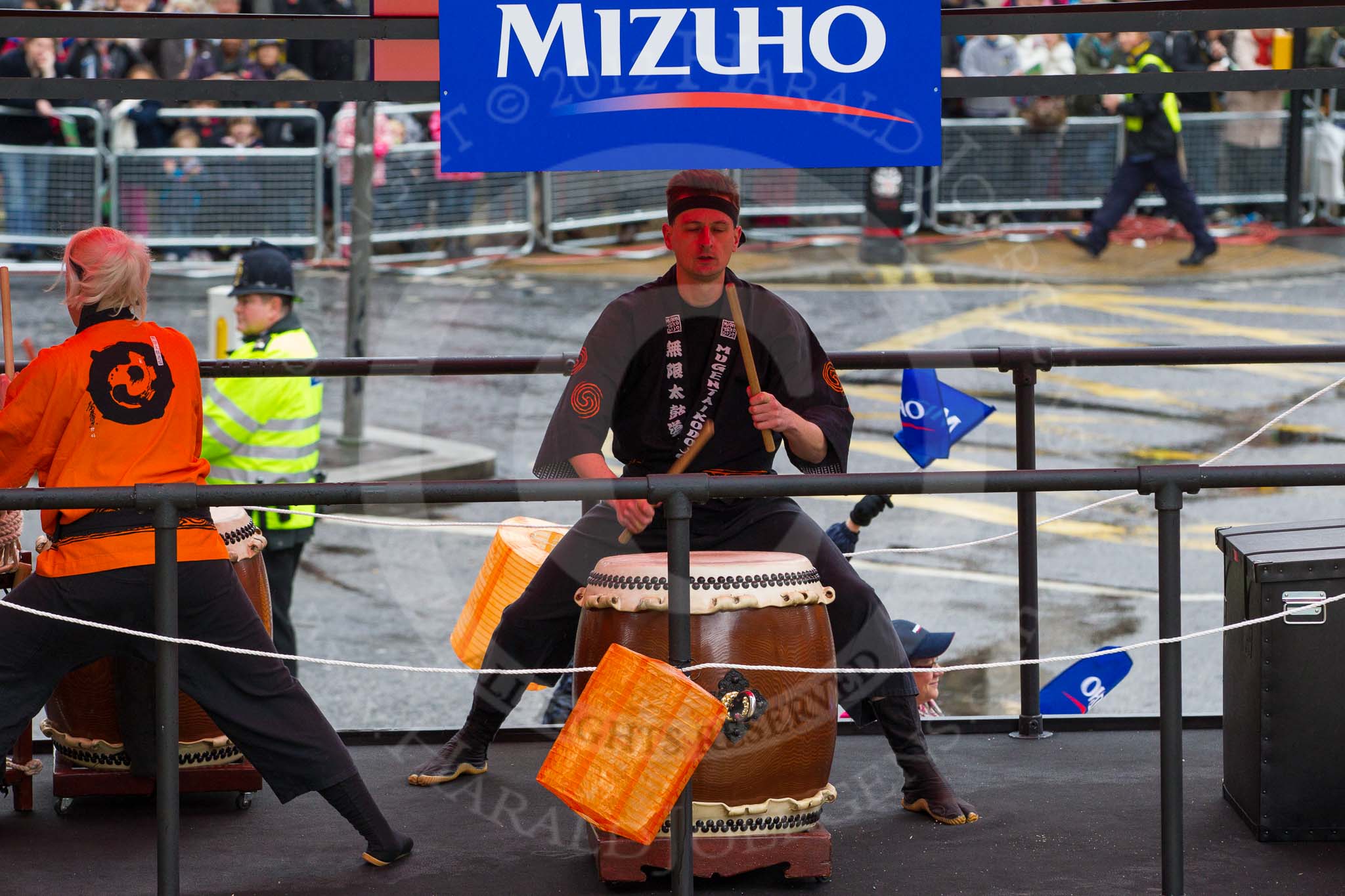 Lord Mayor's Show 2012: Entry 6, Mizuho Corporate Bank, with the drum group Mugenkyo Taiko..
Press stand opposite Mansion House, City of London,
London,
Greater London,
United Kingdom,
on 10 November 2012 at 11:01, image #210