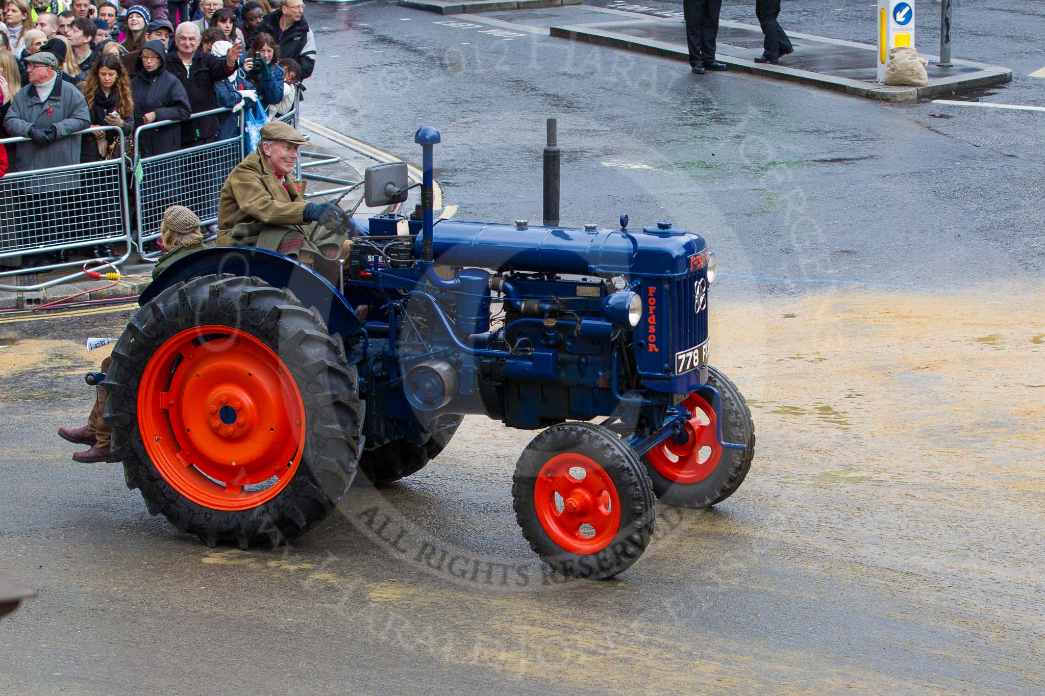Lord Mayor's Show 2012: Entrry 104 - Modern Livery Companies, representing 26 Livery Companies, here the farmers with  1950 Fordson Major tractor..
Press stand opposite Mansion House, City of London,
London,
Greater London,
United Kingdom,
on 10 November 2012 at 11:52, image #1450