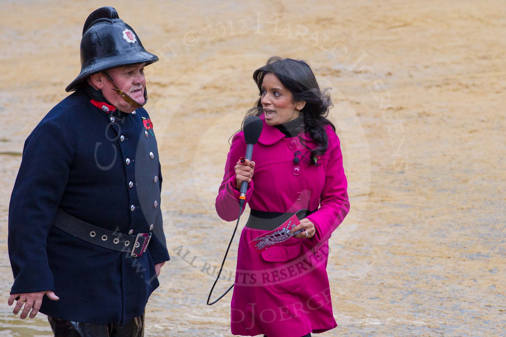 Lord Mayor's Show 2012: Entrry 104 - Modern Livery Companies, representing 26 Livery Companies, here with the BBC's Sonali Shah interviewing a fire fighter..
Press stand opposite Mansion House, City of London,
London,
Greater London,
United Kingdom,
on 10 November 2012 at 11:52, image #1459