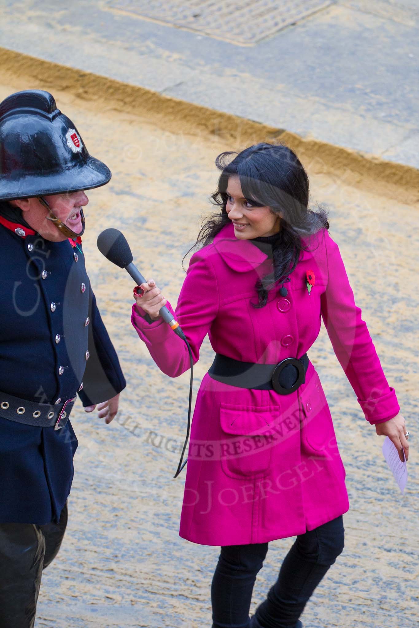 Lord Mayor's Show 2012: Entrry 104 - Modern Livery Companies, representing 26 Livery Companies, here with the BBC's Sonali Shah interviewing a fire fighter..
Press stand opposite Mansion House, City of London,
London,
Greater London,
United Kingdom,
on 10 November 2012 at 11:52, image #1465