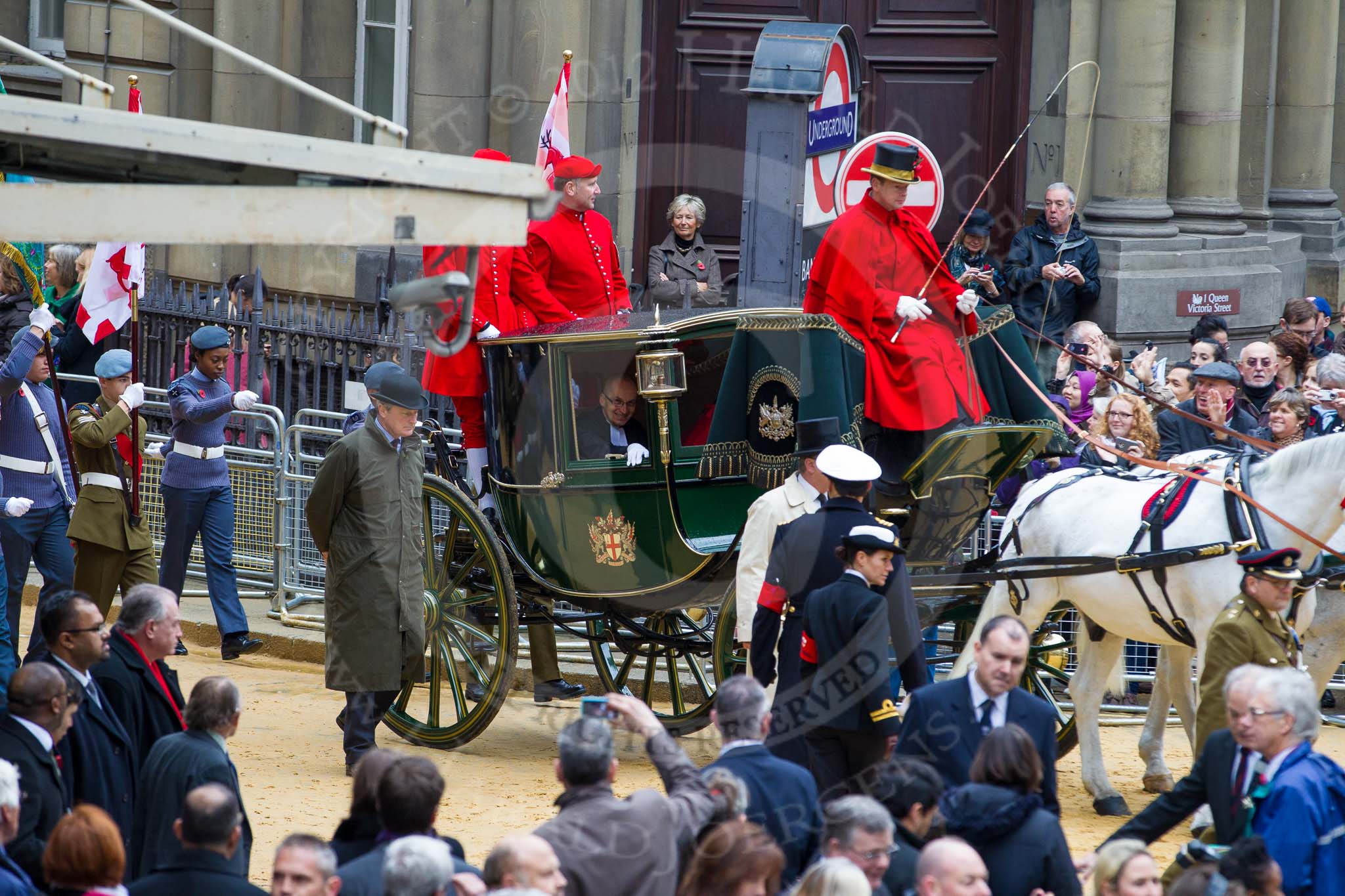 Lord Mayor's Show 2012: Entry 142 - Late Lord Mayor, Alderman and Mrs David Wootton, with the Chaplain Andrew Walker, escorted by four Yeoman Warders and cadets of 1475 (Dulwich) Squadron. Two Dogget's Coat and Badge men stand on the rear of the carriage..
Press stand opposite Mansion House, City of London,
London,
Greater London,
United Kingdom,
on 10 November 2012 at 12:07, image #1901
