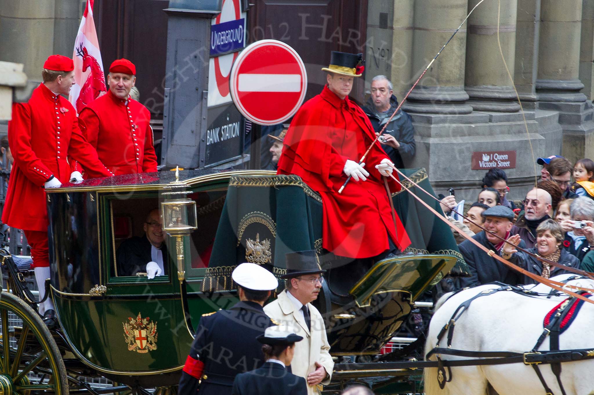 Lord Mayor's Show 2012: Entry 142 - Late Lord Mayor, Alderman and Mrs David Wootton, with the Chaplain Andrew Walker, escorted by four Yeoman Warders and cadets of 1475 (Dulwich) Squadron. Two Dogget's Coat and Badge men stand on the rear of the carriage..
Press stand opposite Mansion House, City of London,
London,
Greater London,
United Kingdom,
on 10 November 2012 at 12:07, image #1902