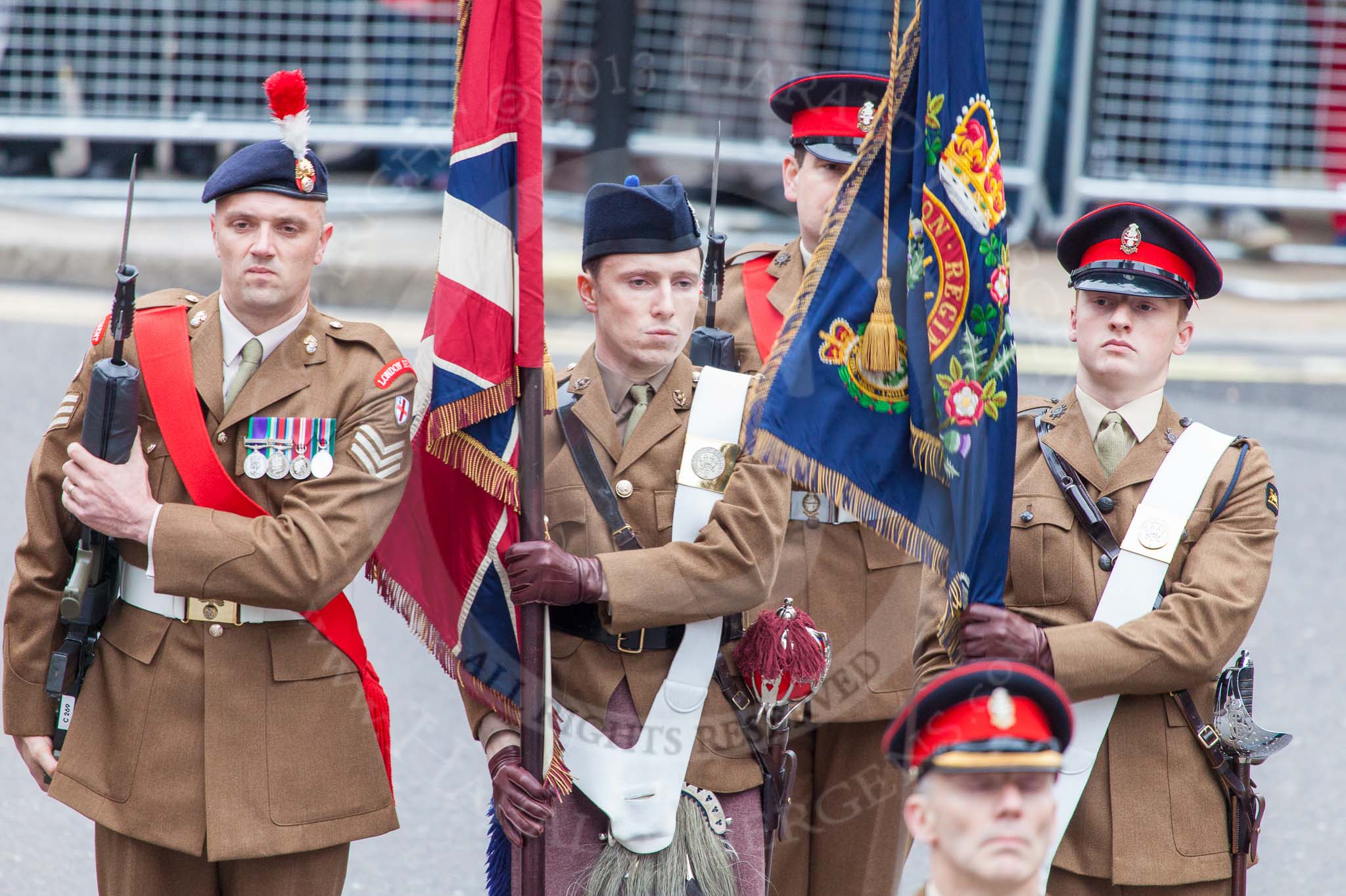 Lord Mayor's Show 2013: The London Regiment, Guard of Honour for the Lord Mayor: Captain Monty D'Iverno, carrying The Queen's Colour, and 2nd Lieutenant Will Clarke, carrying the Regimental Colour..
Press stand opposite Mansion House, City of London,
London,
Greater London,
United Kingdom,
on 09 November 2013 at 10:26, image #64