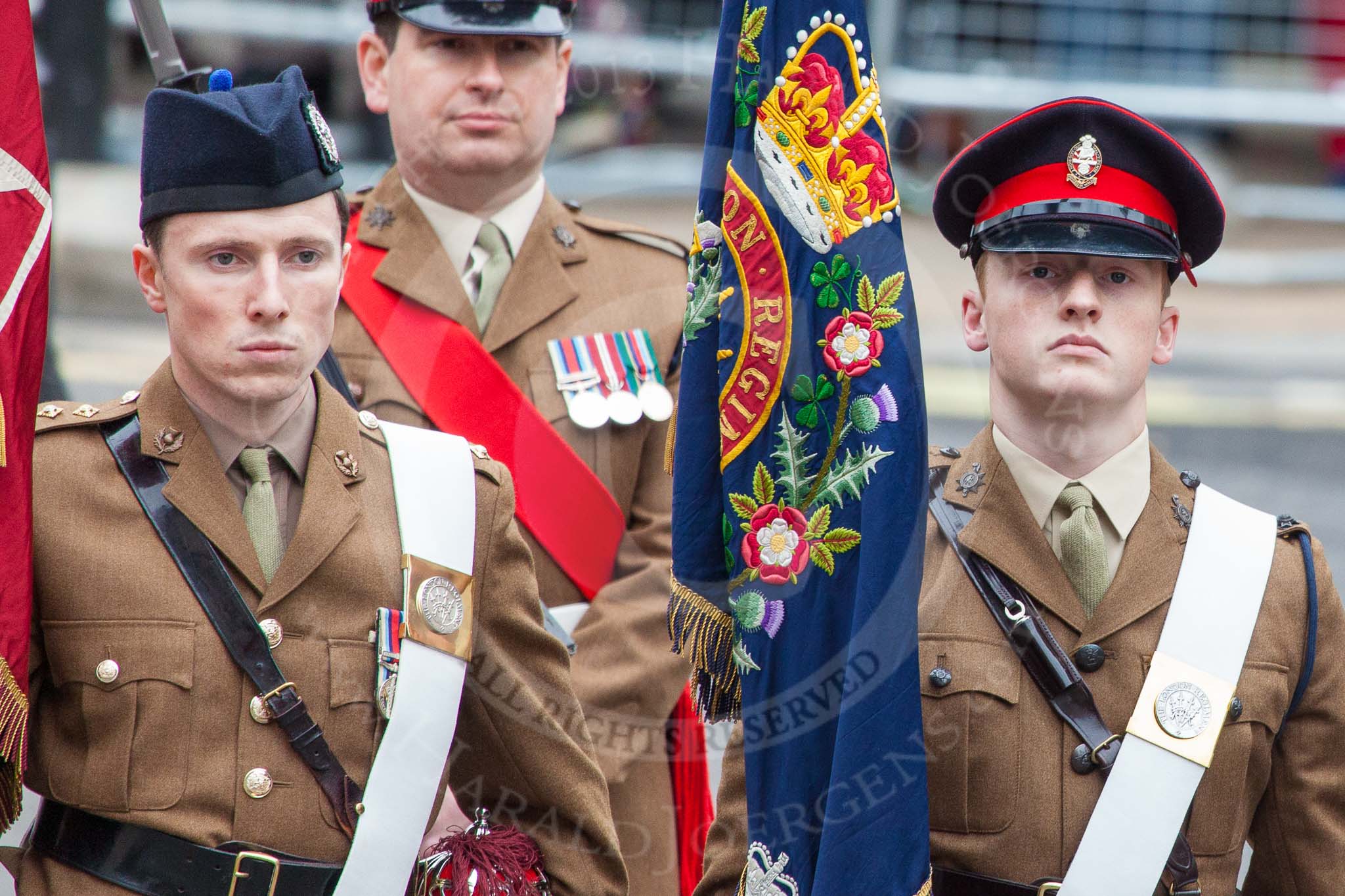 Lord Mayor's Show 2013: Captain Monty D'Iverno, carrying The Queen's Colour, and 2nd Lieutenant Will Clarke, carrying the Regimental Colour of the London Regiment, the Guard of Honour for the Lord Mayor..
Press stand opposite Mansion House, City of London,
London,
Greater London,
United Kingdom,
on 09 November 2013 at 10:27, image #65