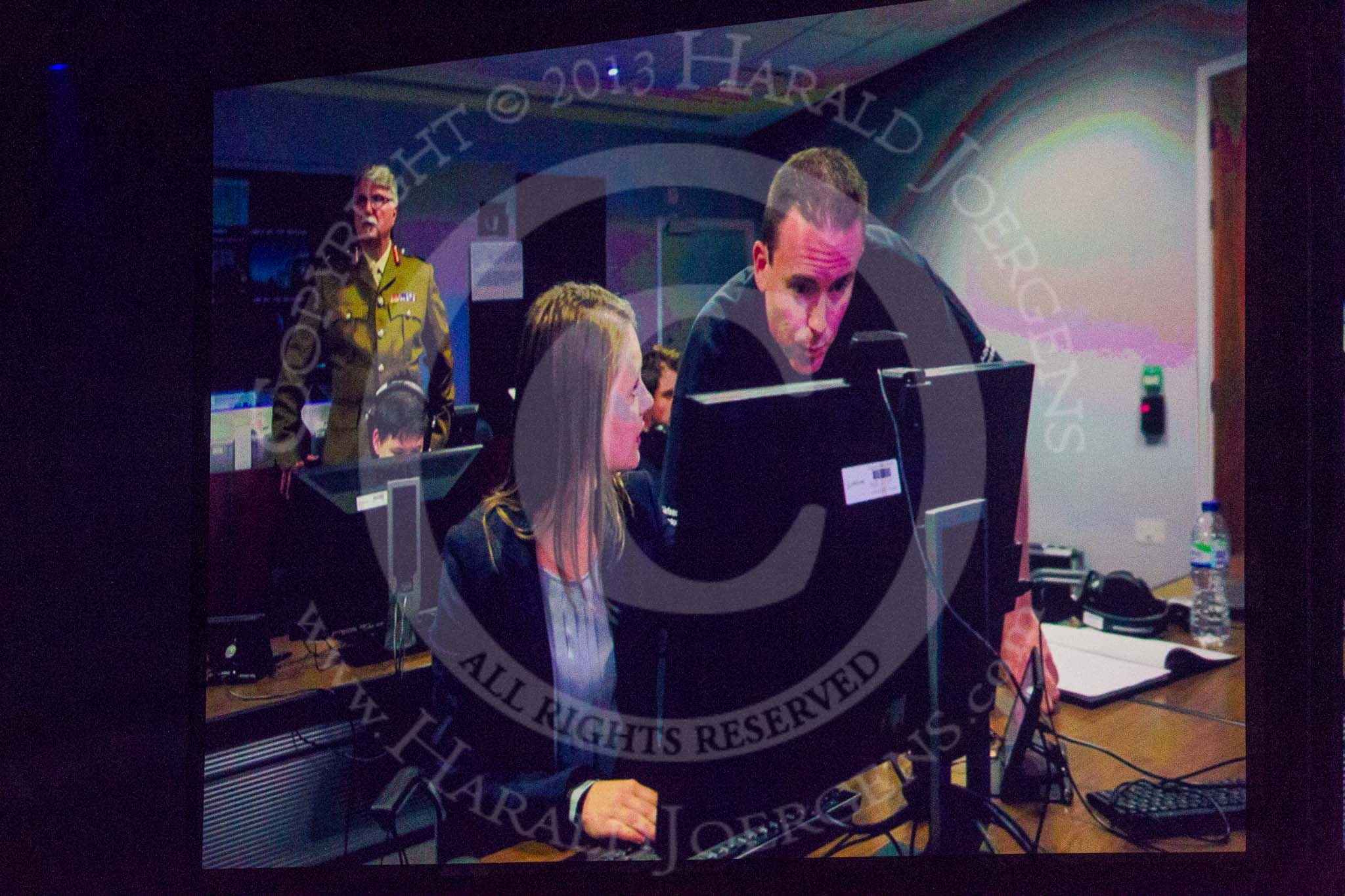 British Military Tournament 2013: Tournament Director Christopher Joll, in the background, playing the role of the Joint Force Commander in the Op Cyber reenactment..
Earls Court,
London SW5,

United Kingdom,
on 06 December 2013 at 16:28, image #418