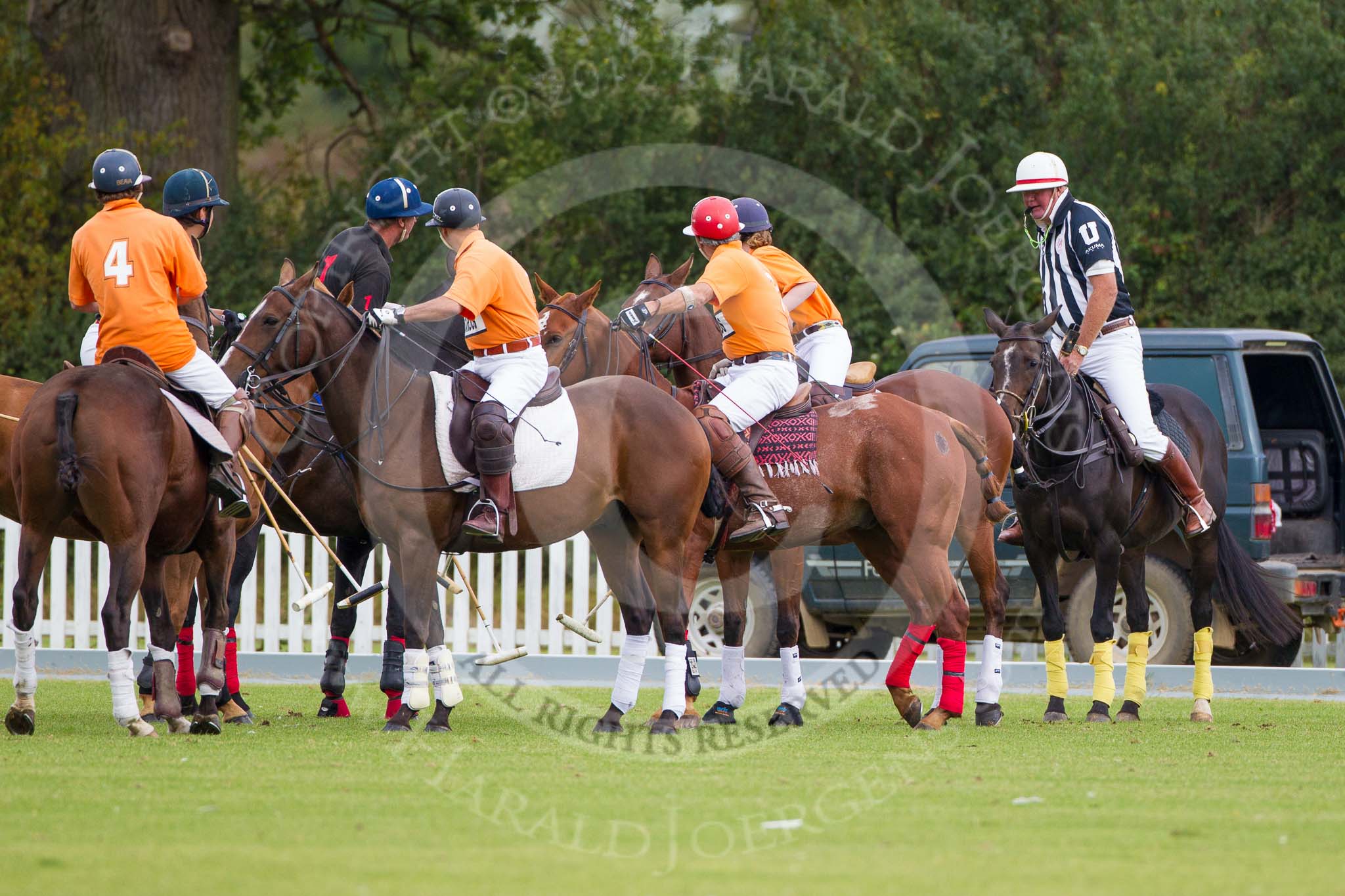 DBPC Polo in the Park 2012: Umpire Ian 'Ginger' Hunt at the throw-in for the first match of the day, between the Kangaroos (in orange) and the  Marston team (in black)..
Dallas Burston Polo Club,
Stoneythorpe Estate,
Southam,
Warwickshire,
United Kingdom,
on 16 September 2012 at 10:11, image #31