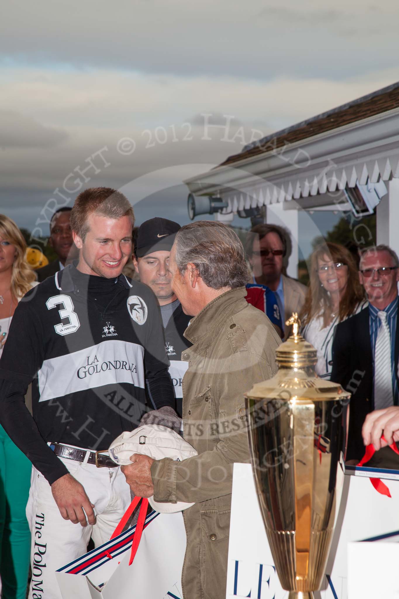 DBPC Polo in the Park 2012: Paul Oberschneider, patron of the La Golondrina polo team that won the  Dallas Burston Gold Cup Tournament, with #3 player Pedro Harrison..
Dallas Burston Polo Club,
Stoneythorpe Estate,
Southam,
Warwickshire,
United Kingdom,
on 16 September 2012 at 18:11, image #309