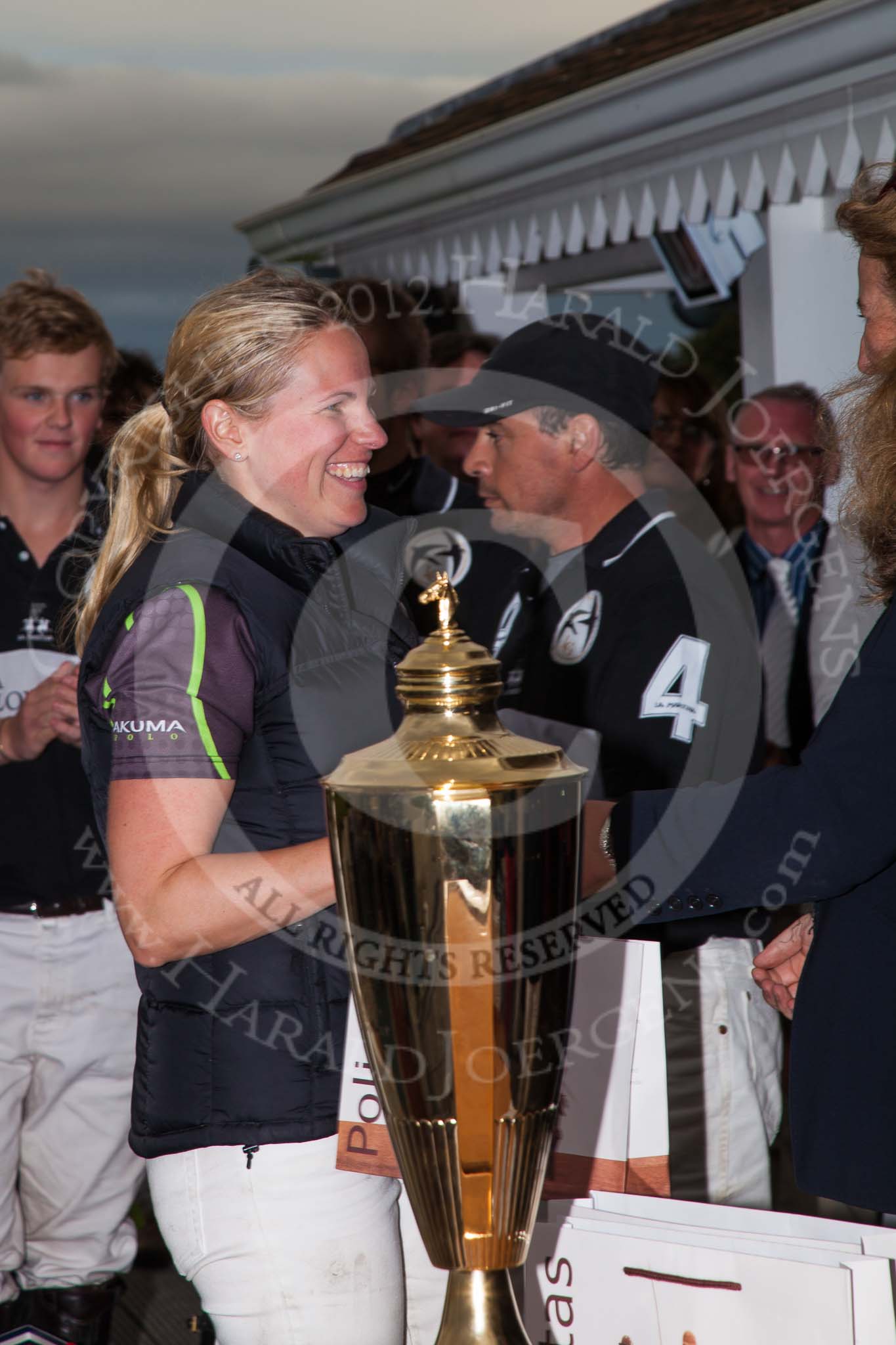 DBPC Polo in the Park 2012: Runner-up for the Dallas Burston Gold Cup Tournament was the team Rigby & Rigby. Here: Jenny Rigby, behind her the winning La Golondrina team..
Dallas Burston Polo Club,
Stoneythorpe Estate,
Southam,
Warwickshire,
United Kingdom,
on 16 September 2012 at 18:12, image #313