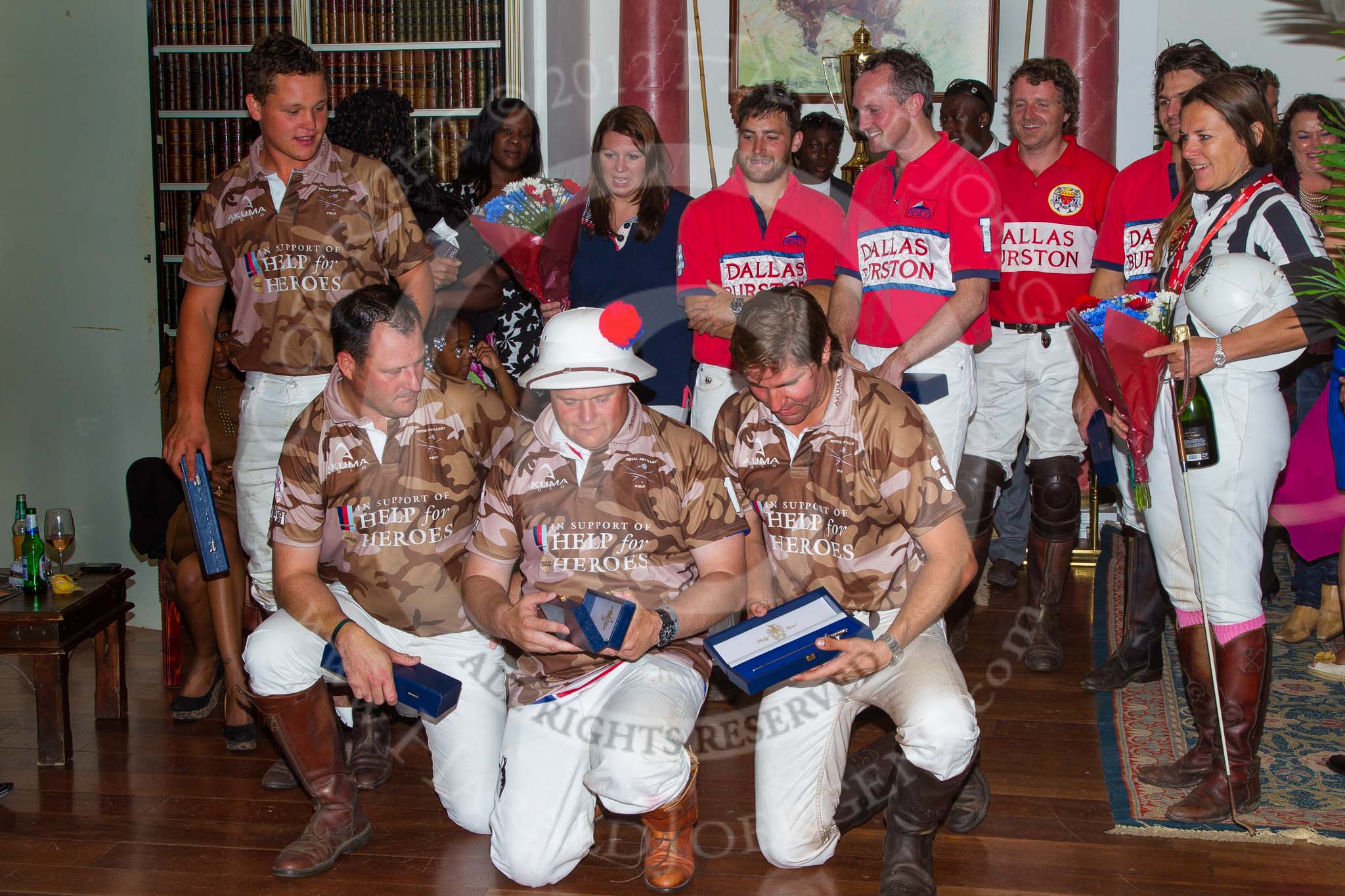 DBPC Polo in the Park 2012: At the price giving for the Help for Heroes Exhibition Game: The Royal Artillery polo team in brown Help for Heroes shirts, the Dallas Burston Polo Club home team in red, and umpire Barbara Zingg..
Dallas Burston Polo Club,
Stoneythorpe Estate,
Southam,
Warwickshire,
United Kingdom,
on 16 September 2012 at 19:21, image #361