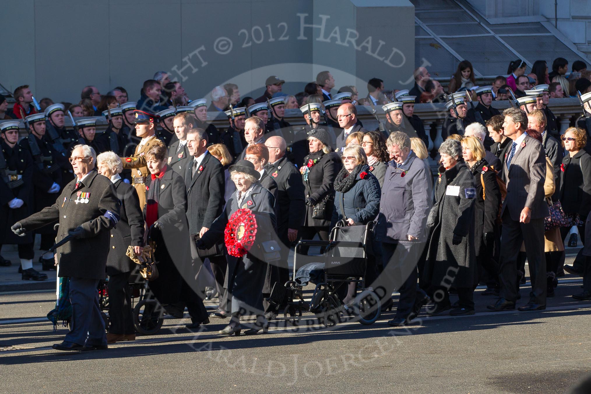 Remembrance Sunday 2012 Cenotaph March Past: Group M4 - Munitions Workers Association and M5  - Children of the Far East Prisoners of War..
Whitehall, Cenotaph,
London SW1,

United Kingdom,
on 11 November 2012 at 12:09, image #1447