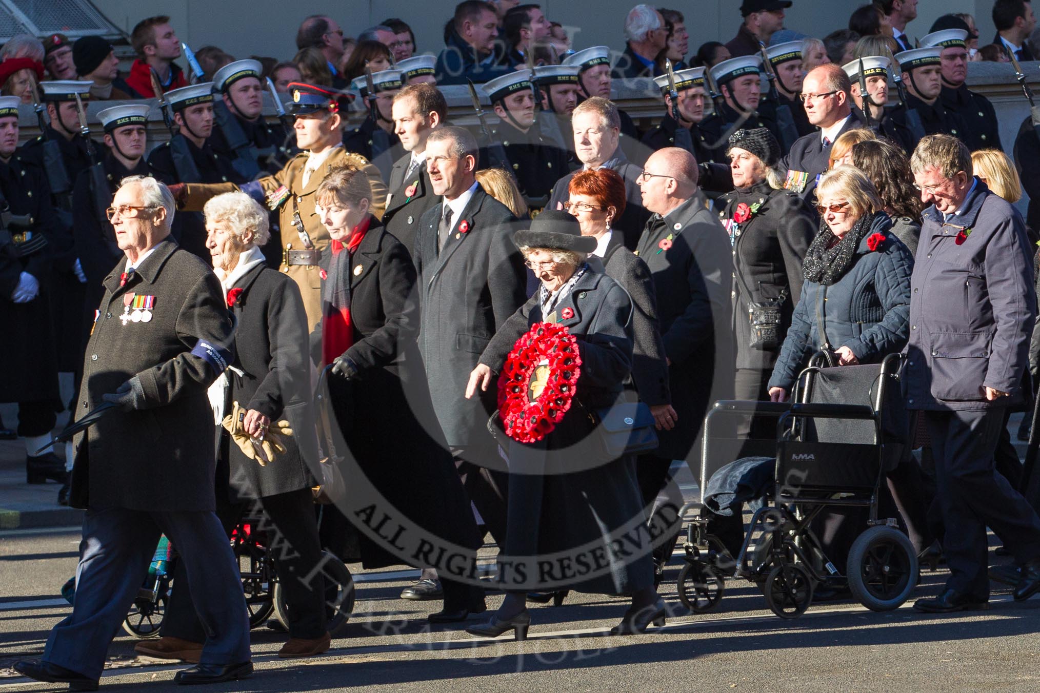 Remembrance Sunday 2012 Cenotaph March Past: Group M4 - Munitions Workers Association and M5  - Children of the Far East Prisoners of War..
Whitehall, Cenotaph,
London SW1,

United Kingdom,
on 11 November 2012 at 12:09, image #1448