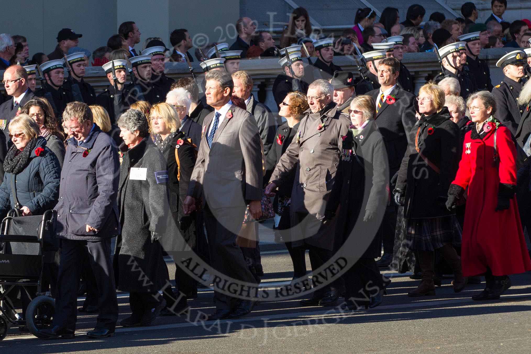 Remembrance Sunday 2012 Cenotaph March Past: Group M4 - Munitions Workers Association and M5  - Children of the Far East Prisoners of War..
Whitehall, Cenotaph,
London SW1,

United Kingdom,
on 11 November 2012 at 12:09, image #1451