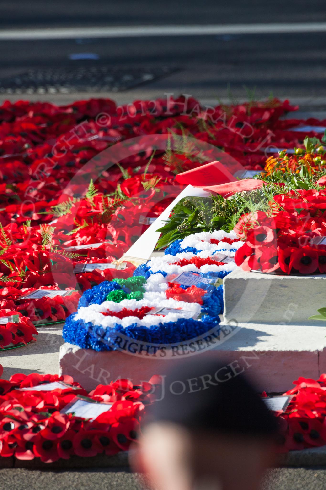 Remembrance Sunday 2012 Cenotaph March Past: The base of the Cenptaph surrounded by poppy-red wreaths after the ceremony and the March Past..
Whitehall, Cenotaph,
London SW1,

United Kingdom,
on 11 November 2012 at 12:18, image #1783