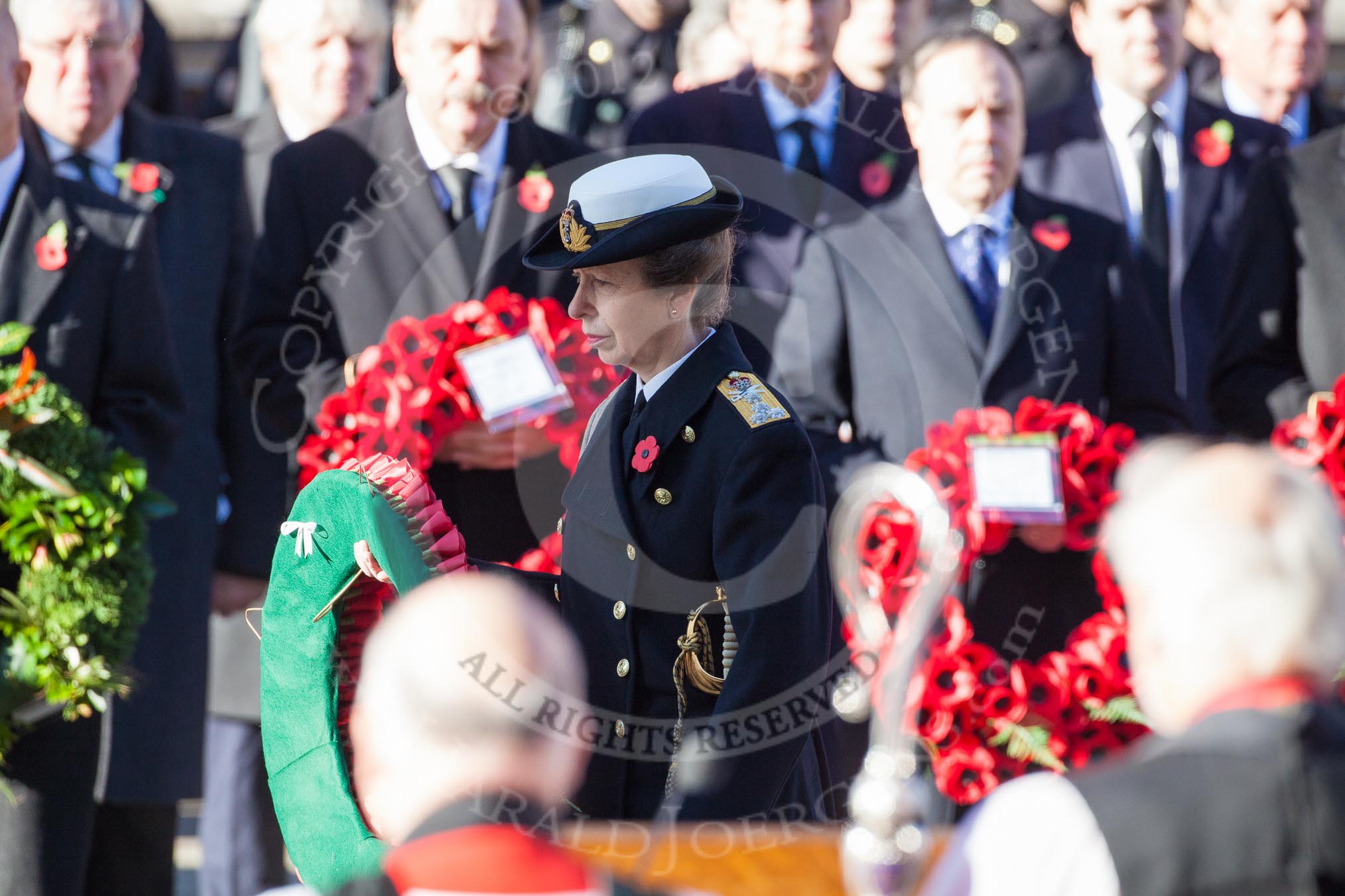 HRH The Princess Royal about to lay her wreath at the Cenotaph. In the foreground, and out of focus, the Bishop of London.