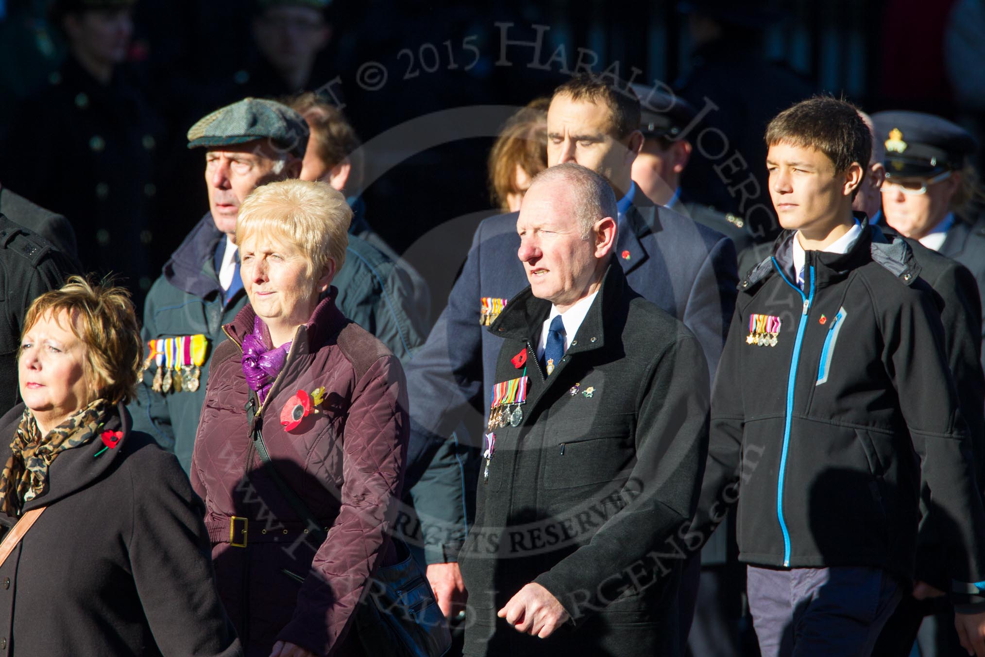 Remembrance Sunday Cenotaph March Past 2013: M23 - Civilians Representing Families..
Press stand opposite the Foreign Office building, Whitehall, London SW1,
London,
Greater London,
United Kingdom,
on 10 November 2013 at 12:12, image #2067