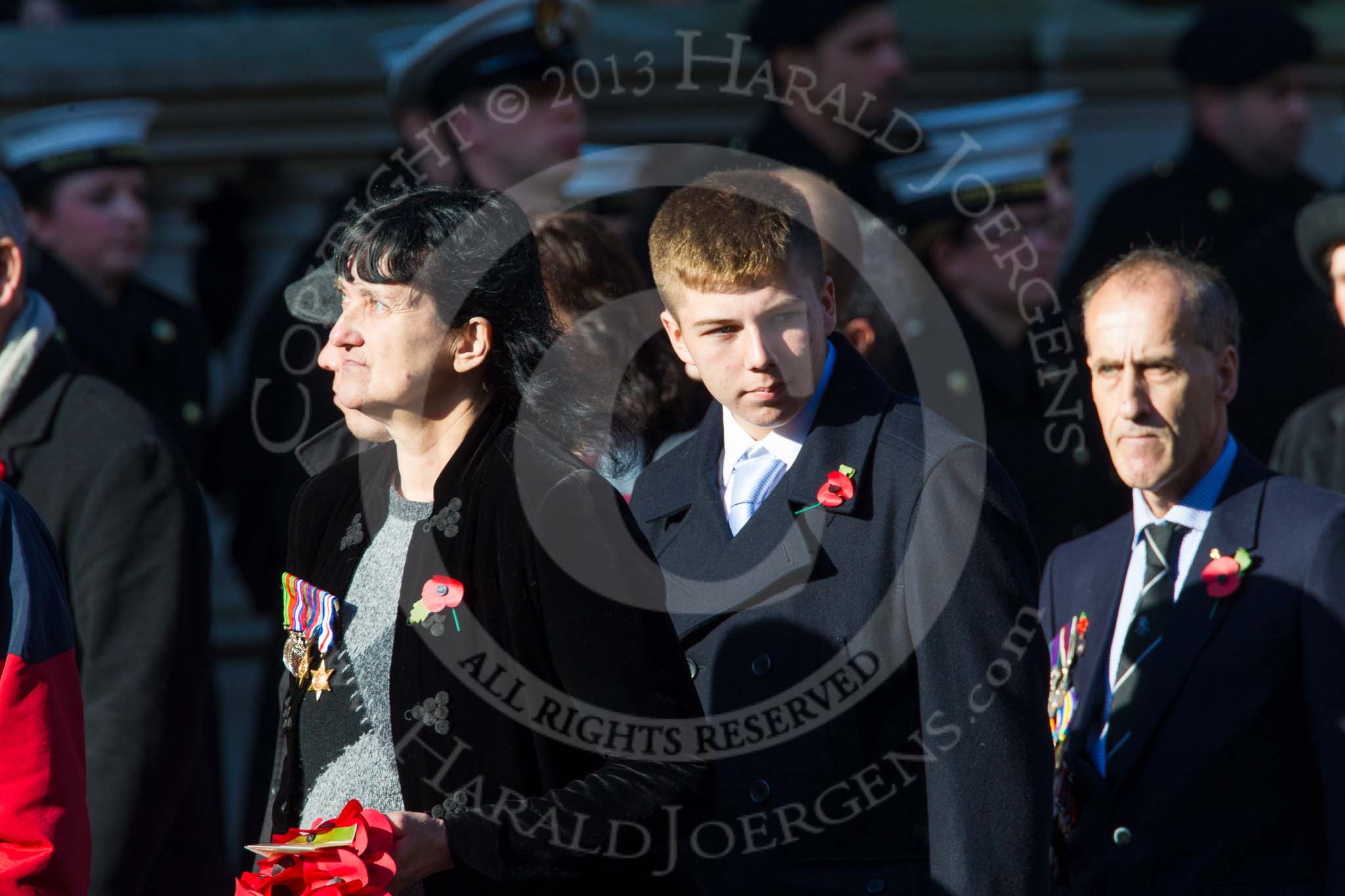 Remembrance Sunday at the Cenotaph in London 2014: Group M23 - Civilians Representing Families.
Press stand opposite the Foreign Office building, Whitehall, London SW1,
London,
Greater London,
United Kingdom,
on 09 November 2014 at 12:18, image #2167