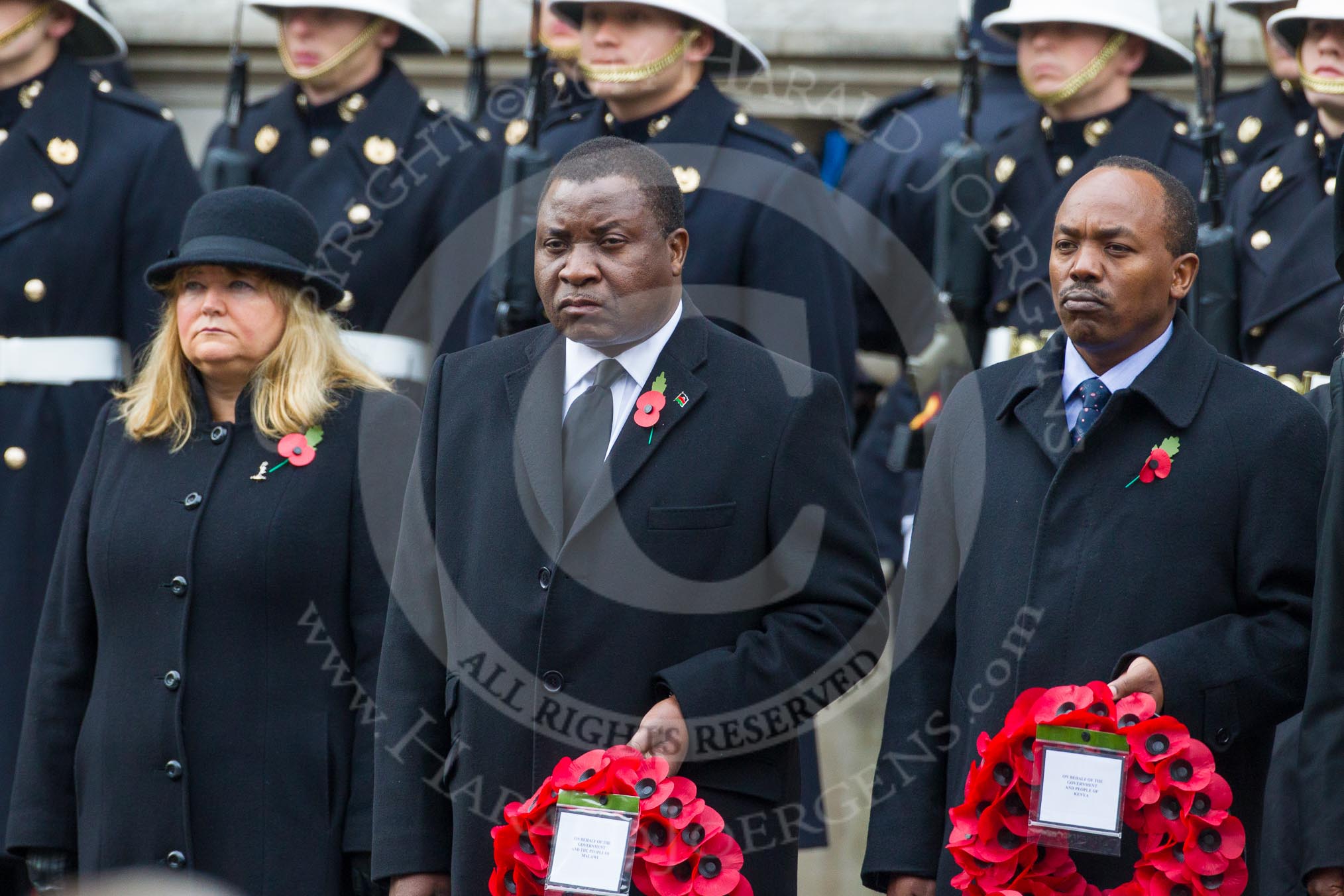 Remembrance Sunday at the Cenotaph in London 2014: The High Commissioner of Malta, the High Commissioner of Malawi, and the Acting High Commissioner of Kenya,  with their wreaths at the Cenotaph.
Press stand opposite the Foreign Office building, Whitehall, London SW1,
London,
Greater London,
United Kingdom,
on 09 November 2014 at 11:02, image #173