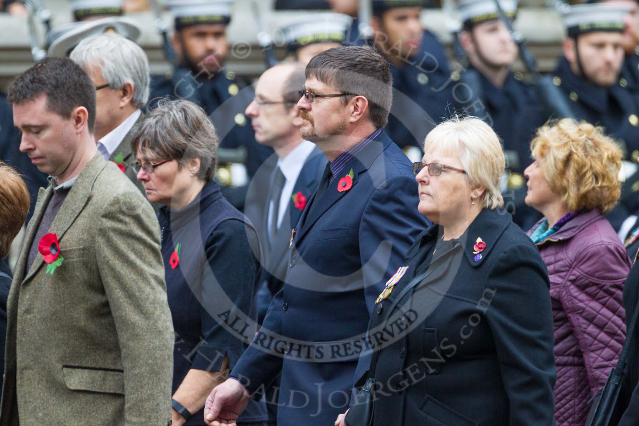 Remembrance Sunday at the Cenotaph 2015: Group M23, Civilians Representing Families.
Cenotaph, Whitehall, London SW1,
London,
Greater London,
United Kingdom,
on 08 November 2015 at 12:17, image #1565