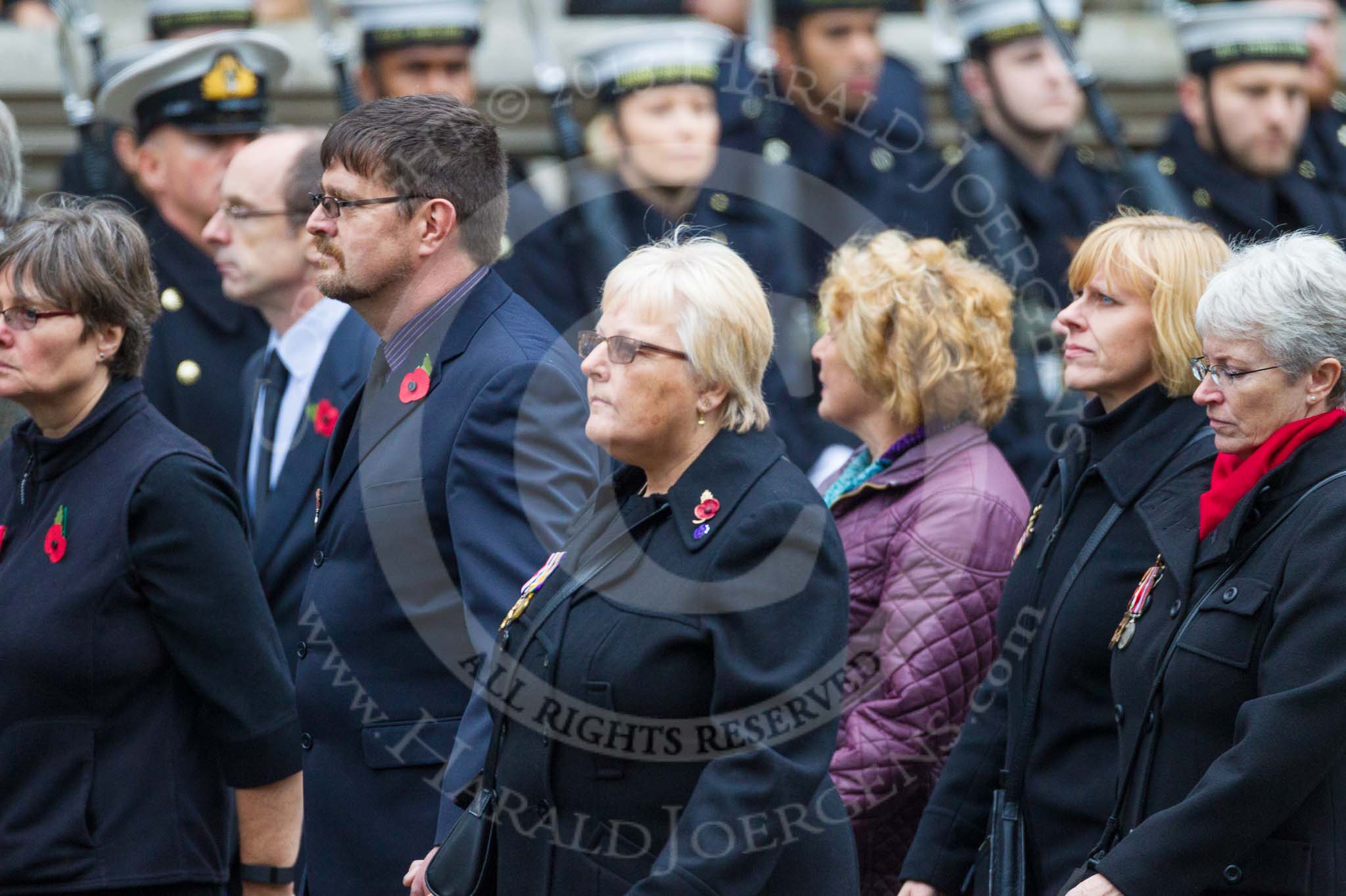 Remembrance Sunday at the Cenotaph 2015: Group M23, Civilians Representing Families.
Cenotaph, Whitehall, London SW1,
London,
Greater London,
United Kingdom,
on 08 November 2015 at 12:17, image #1566