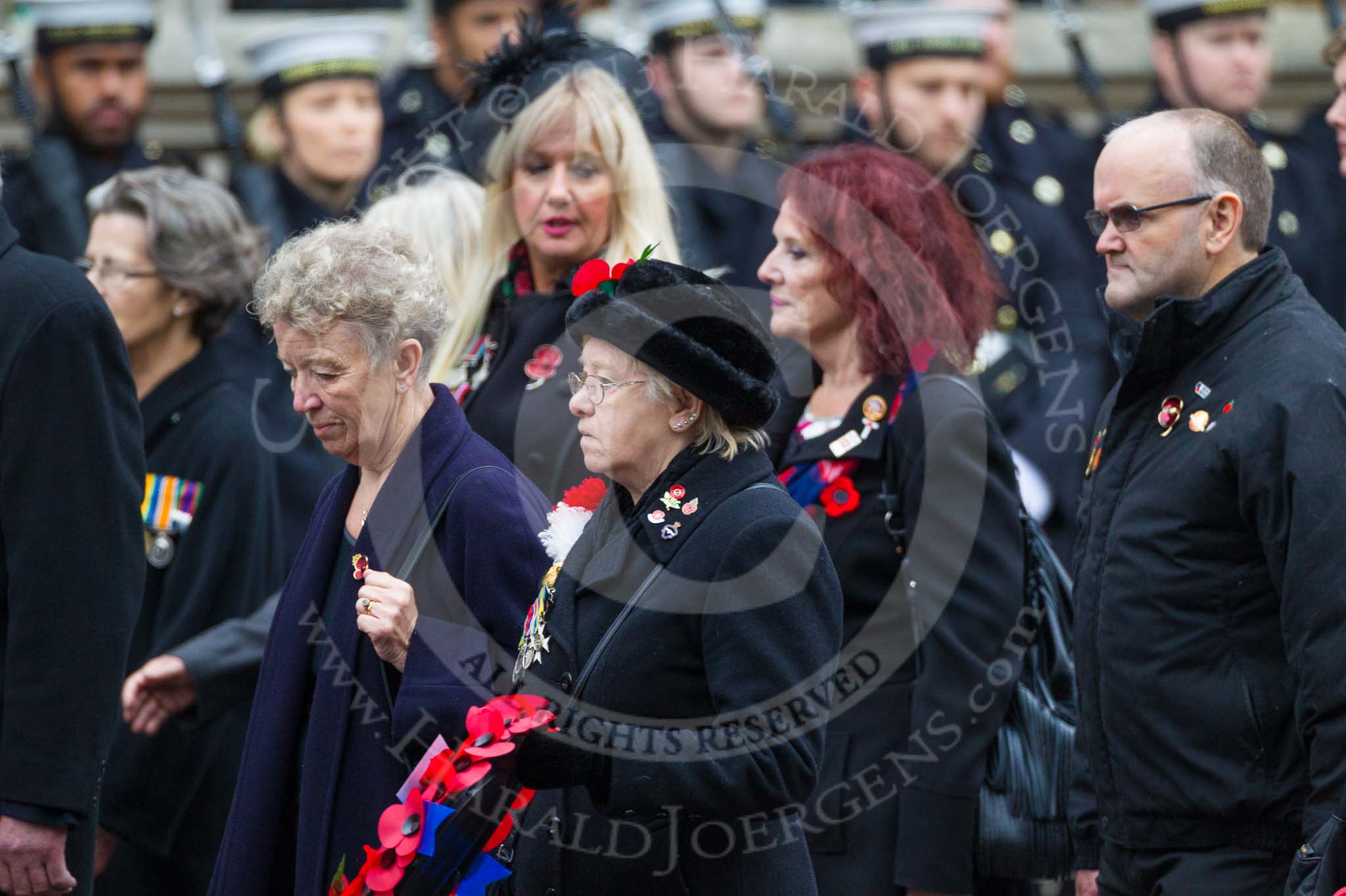 Remembrance Sunday at the Cenotaph 2015: Group M23, Civilians Representing Families.
Cenotaph, Whitehall, London SW1,
London,
Greater London,
United Kingdom,
on 08 November 2015 at 12:17, image #1573