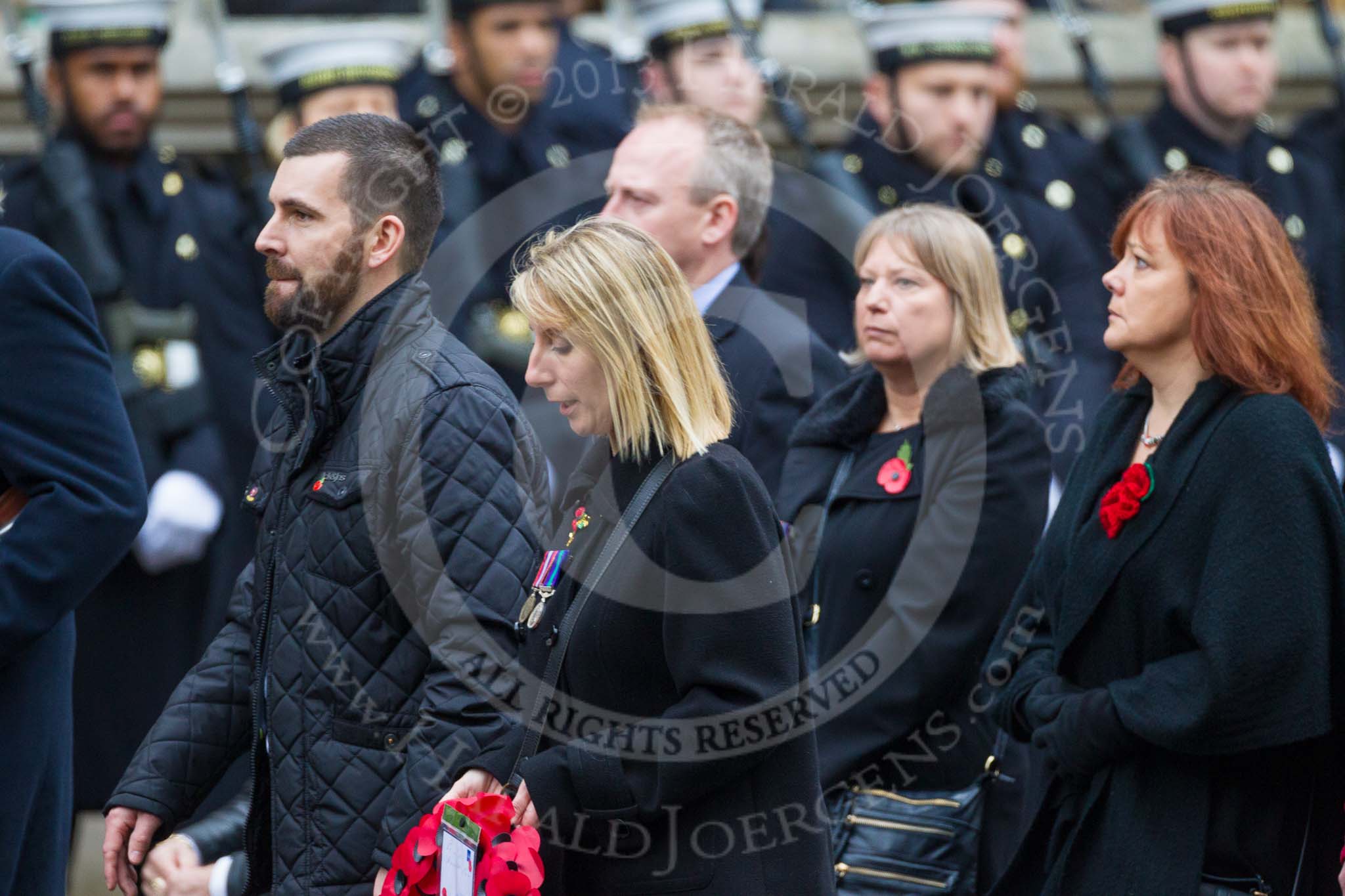 Remembrance Sunday at the Cenotaph 2015: Group M23, Civilians Representing Families.
Cenotaph, Whitehall, London SW1,
London,
Greater London,
United Kingdom,
on 08 November 2015 at 12:17, image #1576