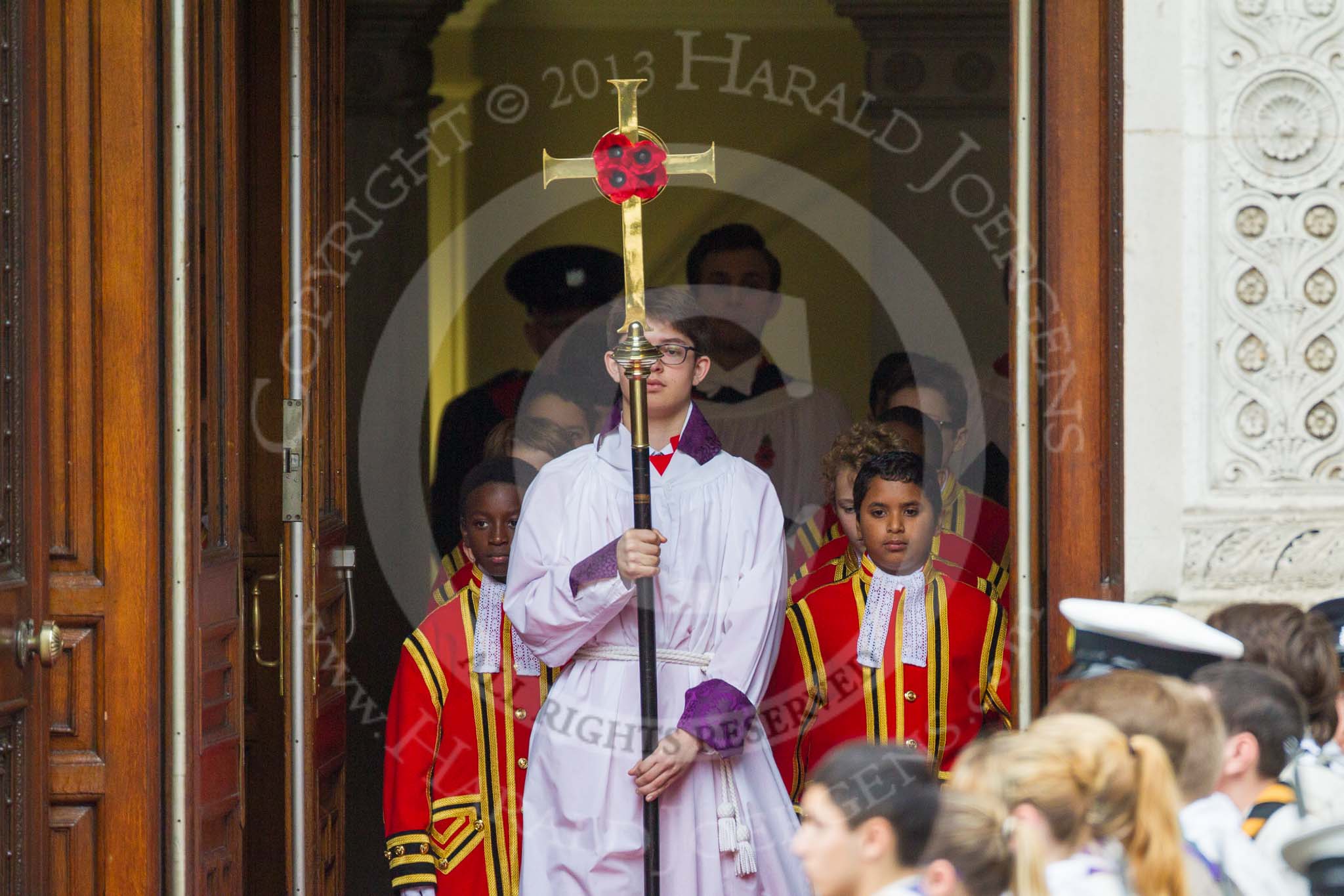 Remembrance Sunday at the Cenotaph 2015: The choir, led by the Cross Bearer, Jason Panagiotopoulos, is emerging from the Foreign- and Commonwealth Office Building, followed by the 10 Children of the Chapel Royal. Image #73, 08 November 2015 10:53 Whitehall, London, UK