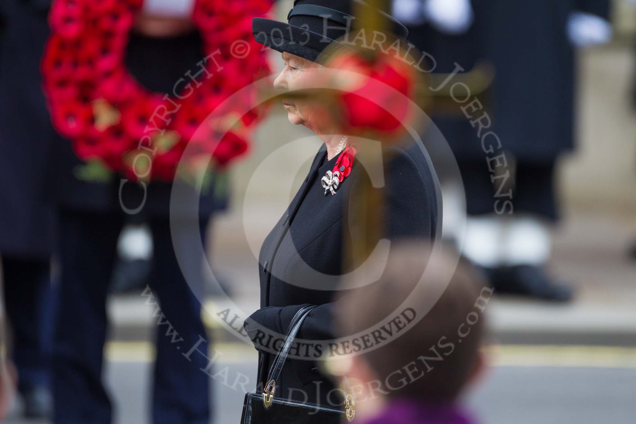 Remembrance Sunday at the Cenotaph 2015: HM The Queen, her face partially hidden by the cross. Image #159, 08 November 2015 11:02 Whitehall, London, UK