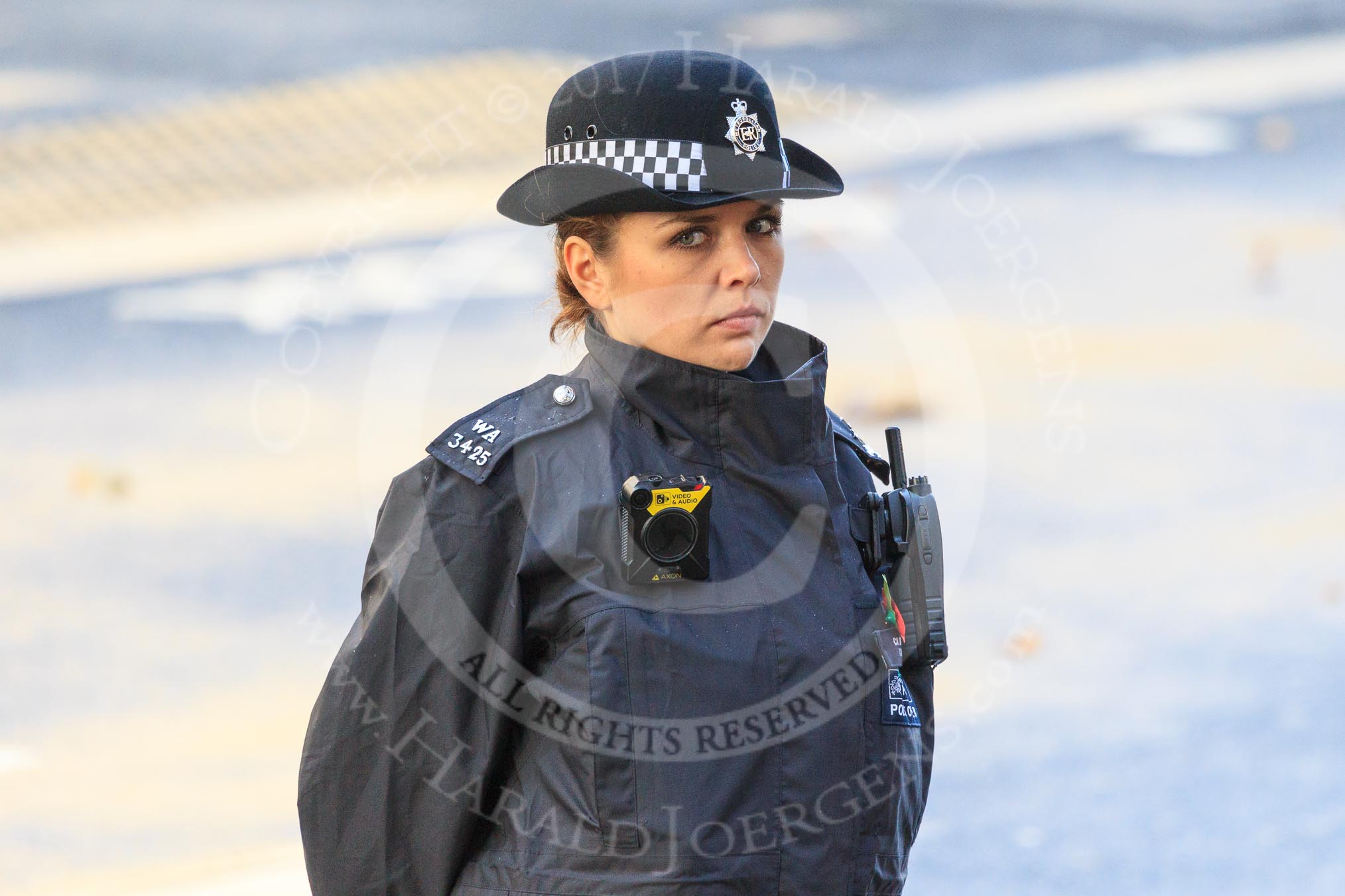 A female Metropolitan Police Constable keeping an eye on the crowds during Remembrance Sunday Cenotaph Ceremony 2018 at Horse Guards Parade, Westminster, London, 11 November 2018, 08:51.