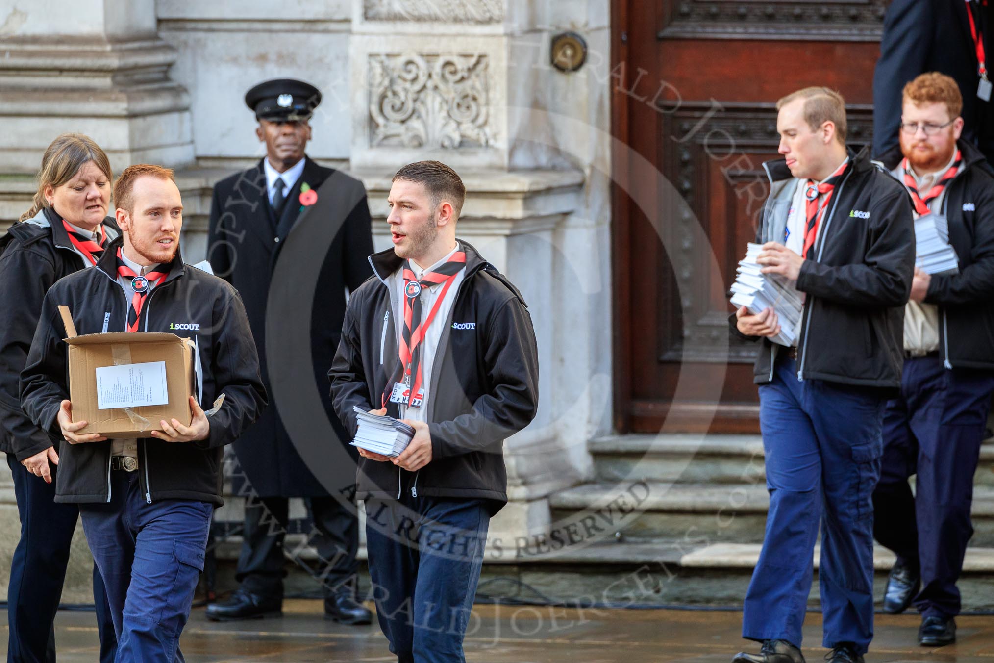 The The Queen's Scouts leaving the Foreign and Commonwealth Office to distribute the Order of Service in Whitehall before Remembrance Sunday Cenotaph Ceremony 2018 at Horse Guards Parade, Westminster, London, 11 November 2018, 09:13.