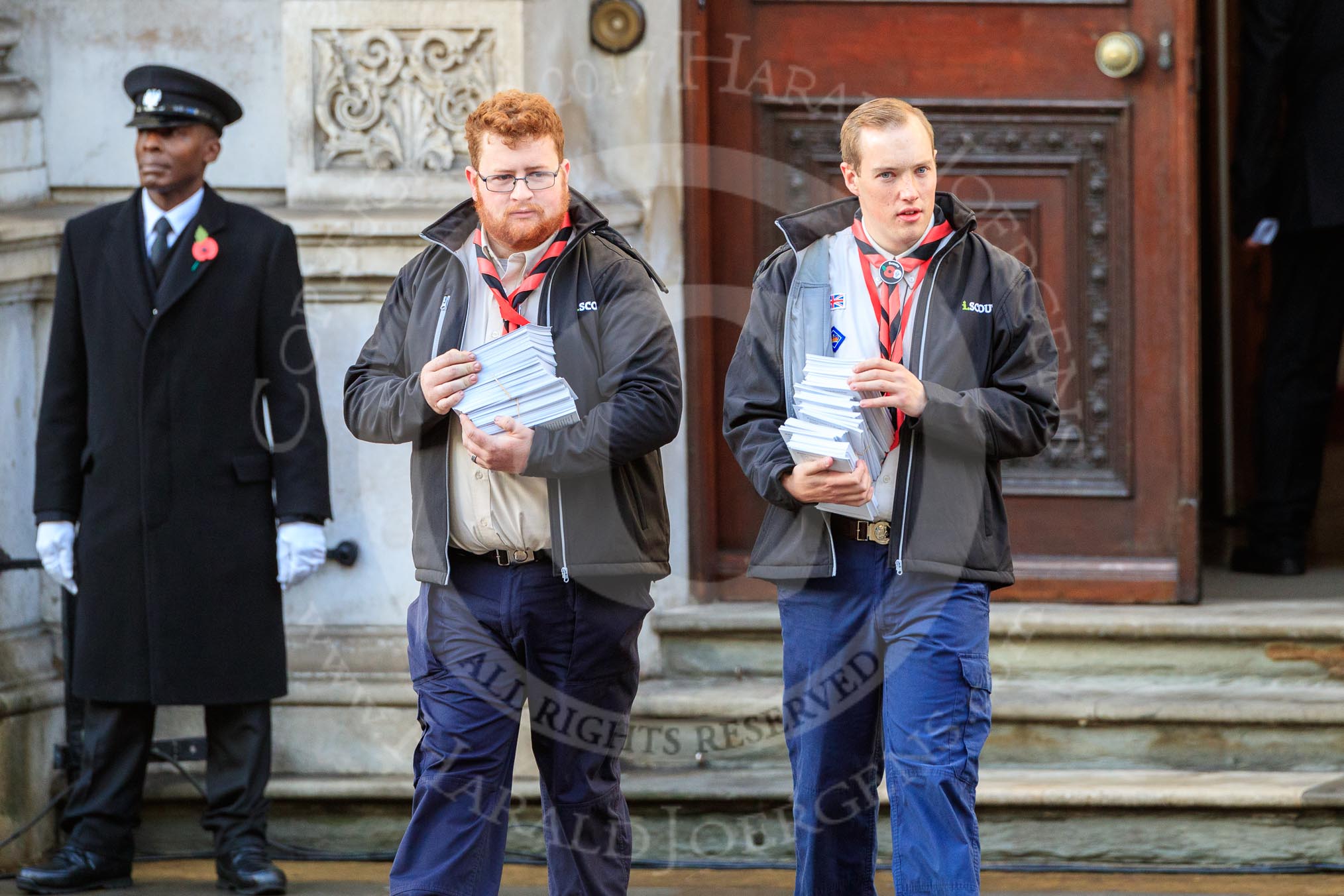 The The Queen's Scouts leaving the Foreign and Commonwealth Office to distribute the Order of Service in Whitehall before the Remembrance Sunday Cenotaph Ceremony 2018 at Horse Guards Parade, Westminster, London, 11 November 2018, 09:13.