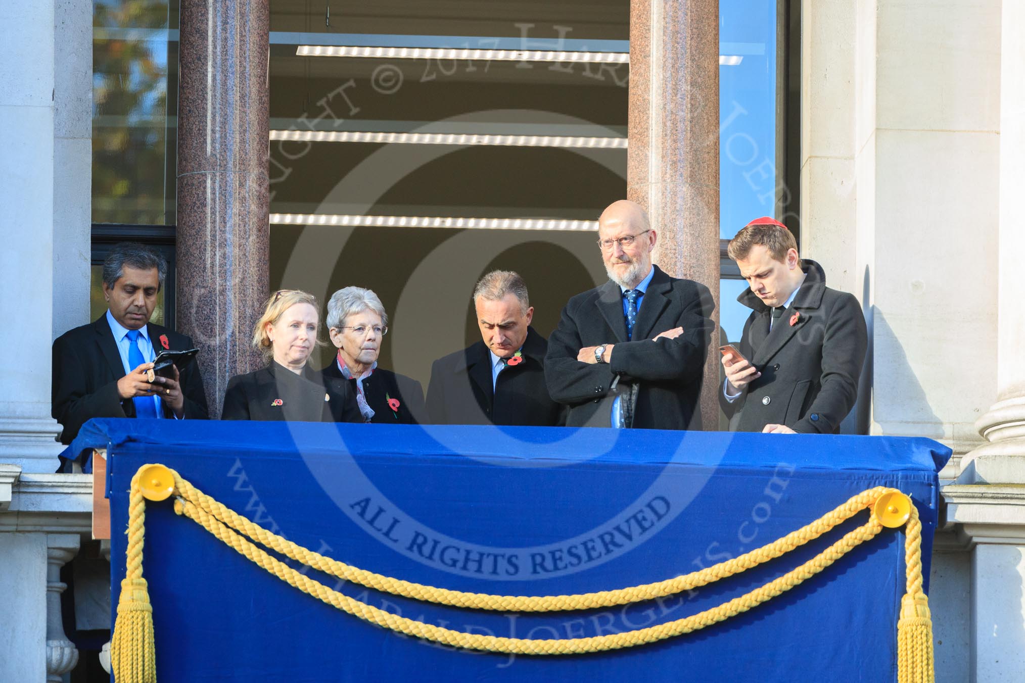 Early guests on one of the balconies of the Foreign and Commonwealth Office before the Remembrance Sunday Cenotaph Ceremony 2018 at Horse Guards Parade, Westminster, London, 11 November 2018, 09:46.