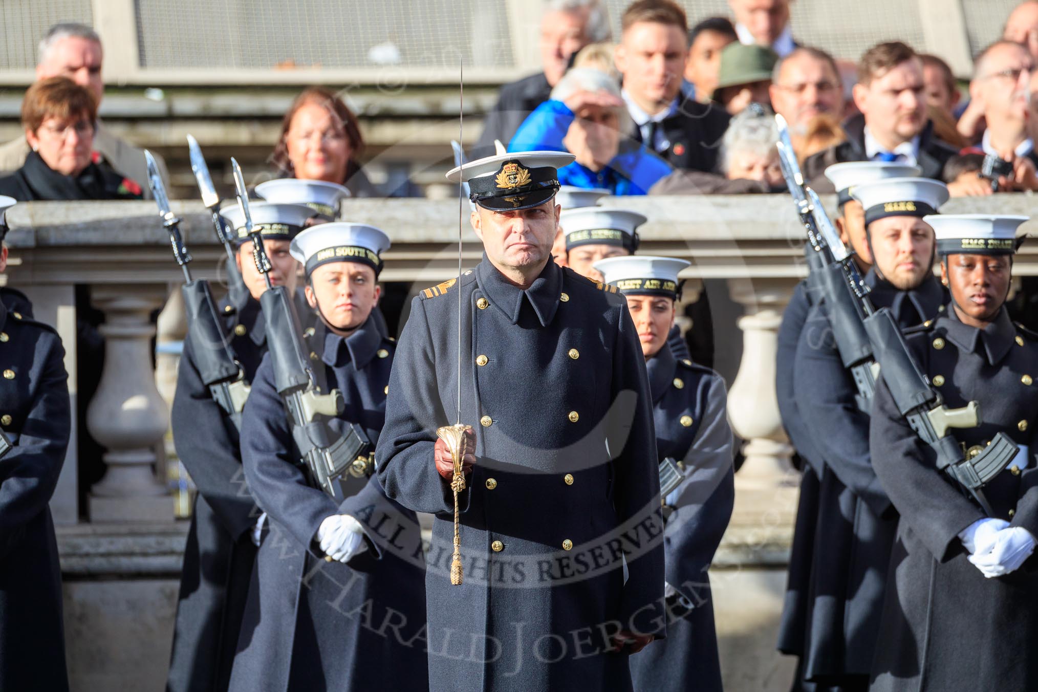 A Lieutenant Commander of the Service detachment from the Royal Navy saluting before the Remembrance Sunday Cenotaph Ceremony 2018 at Horse Guards Parade, Westminster, London, 11 November 2018, 10:23.