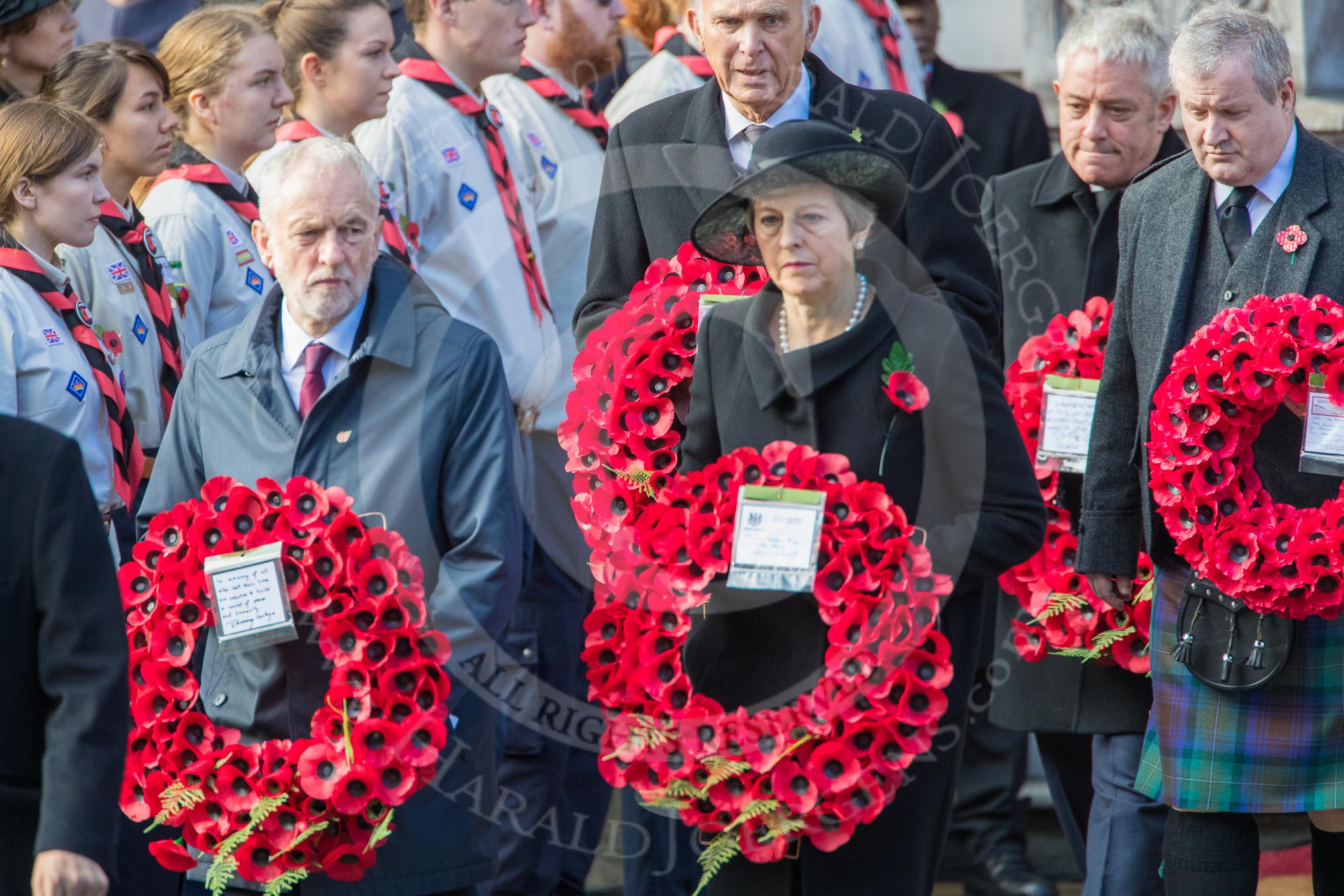 The Rt Hon Jeremy Corbyn MP, (Leader of the Labour Party and Leader of the Opposition)   and the Rt Hon Theresa May MP, Prime Minister, on behalf of the Government, leaving the Foreign and Commonwealth Office with their wreath during Remembrance Sunday Cenotaph Ceremony 2018 at Horse Guards Parade, Westminster, London, 11 November 2018, 10:55.